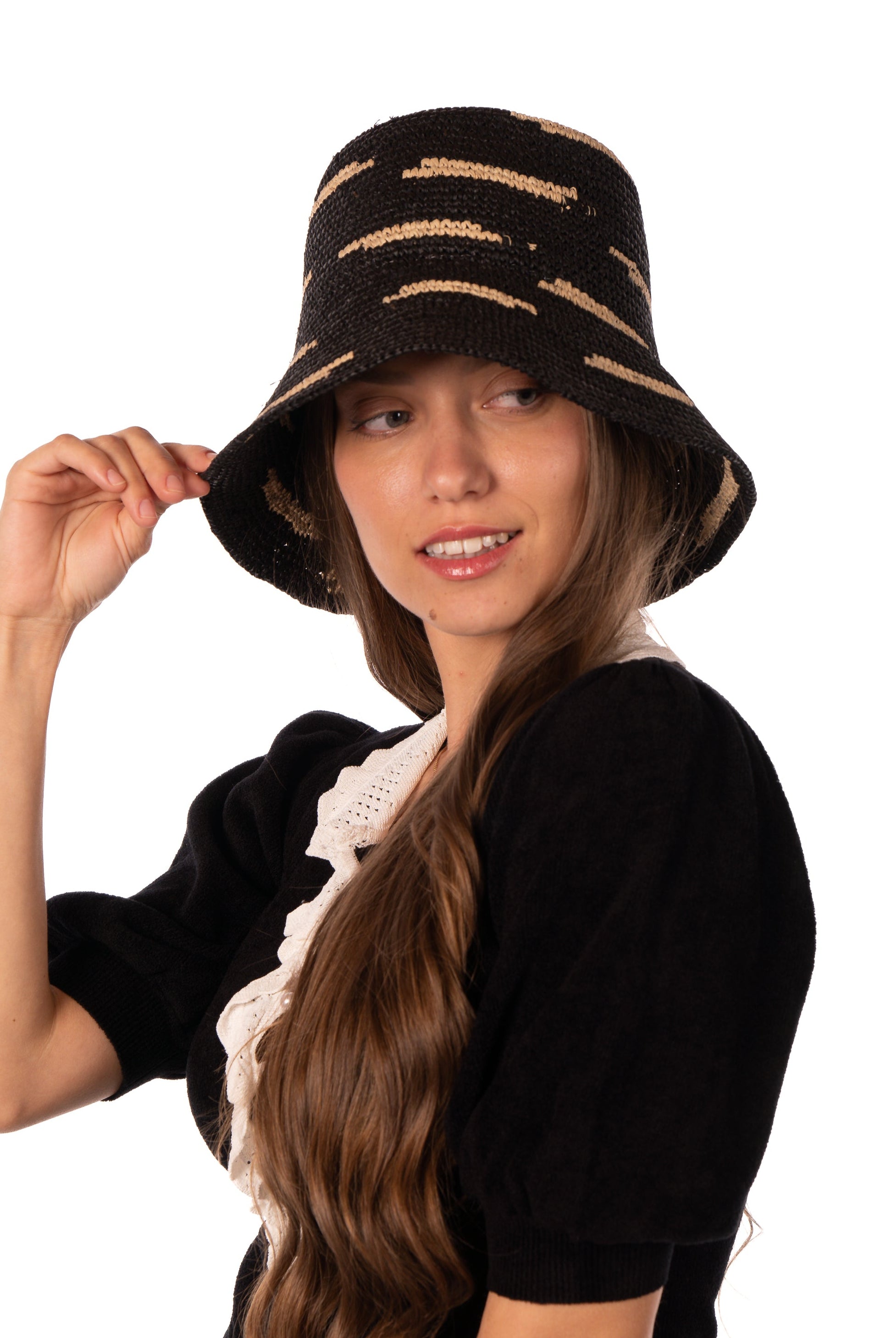 Model wearing 2.5" Brim Taylor Black Crochet Bucket Straw Hat with Zebra Stripes handmade raffia palm fiber in a two tone color combination of horizontal short stripes that create a dash pattern around the hat in black with natural straw color - Shebobo