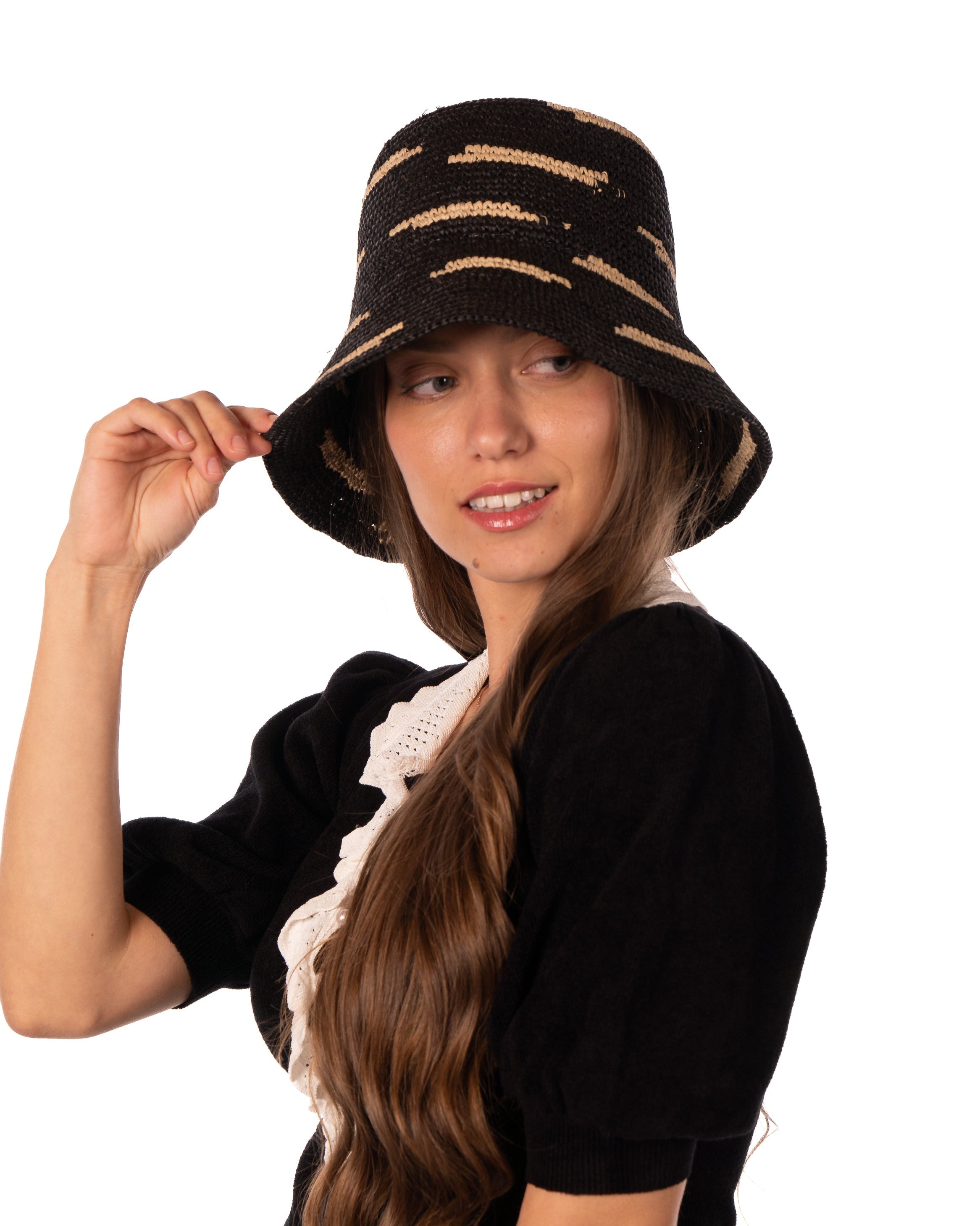 Model wearing 2.5" Brim Taylor Black Crochet Bucket Straw Hat with Zebra Stripes handmade raffia palm fiber in a two tone color combination of horizontal short stripes that create a dash pattern around the hat in black with natural straw color - Shebobo