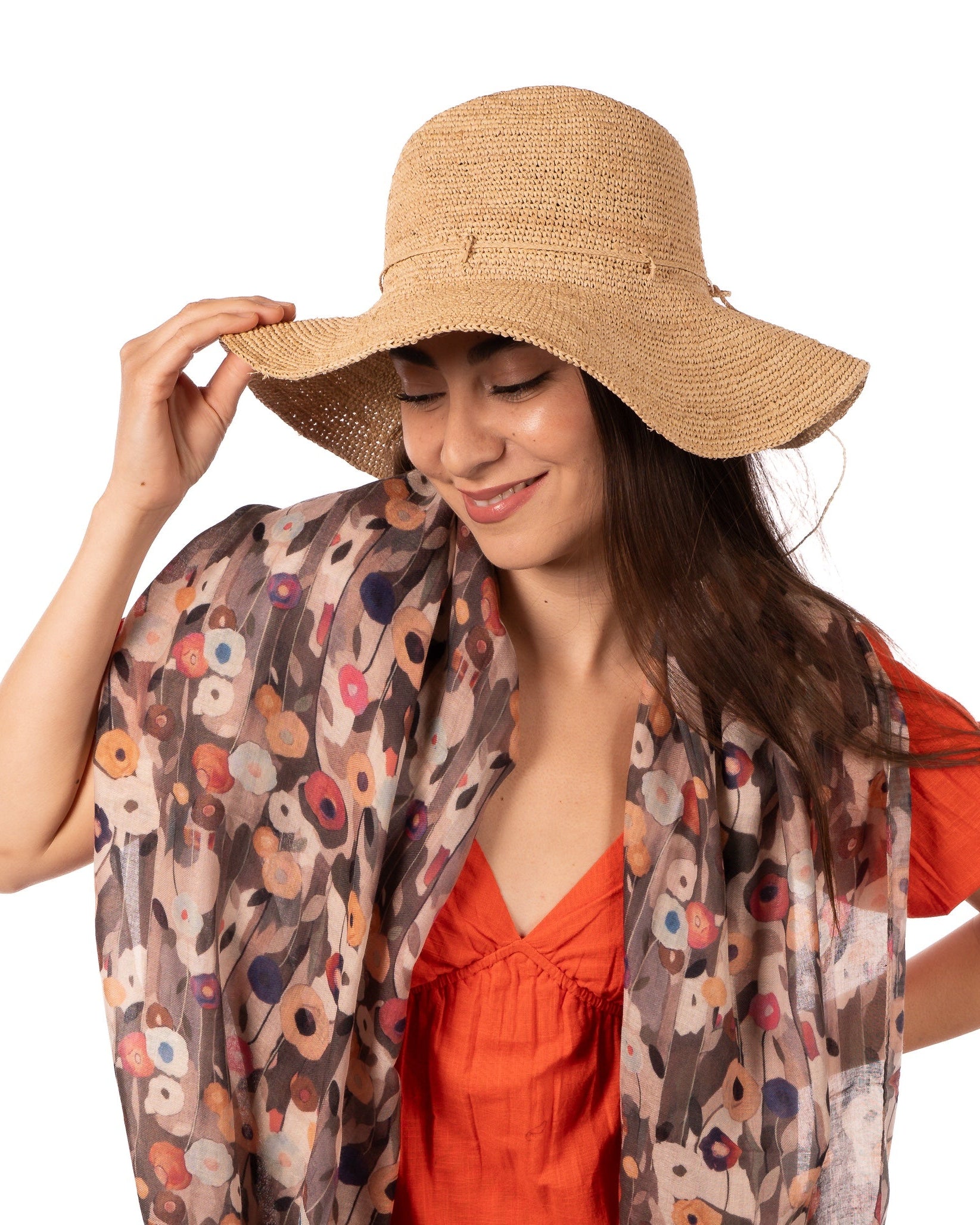 Model wearing Crochet Miramar Straw Sun Hat handmade woven raffia palm fiber in a subtle link pattered solid hue of natural straw color with matching adjustable braided hat band tie wide brim unisex panama style hat - Shebobo (with Poppy Dreams Scarf Wrap)