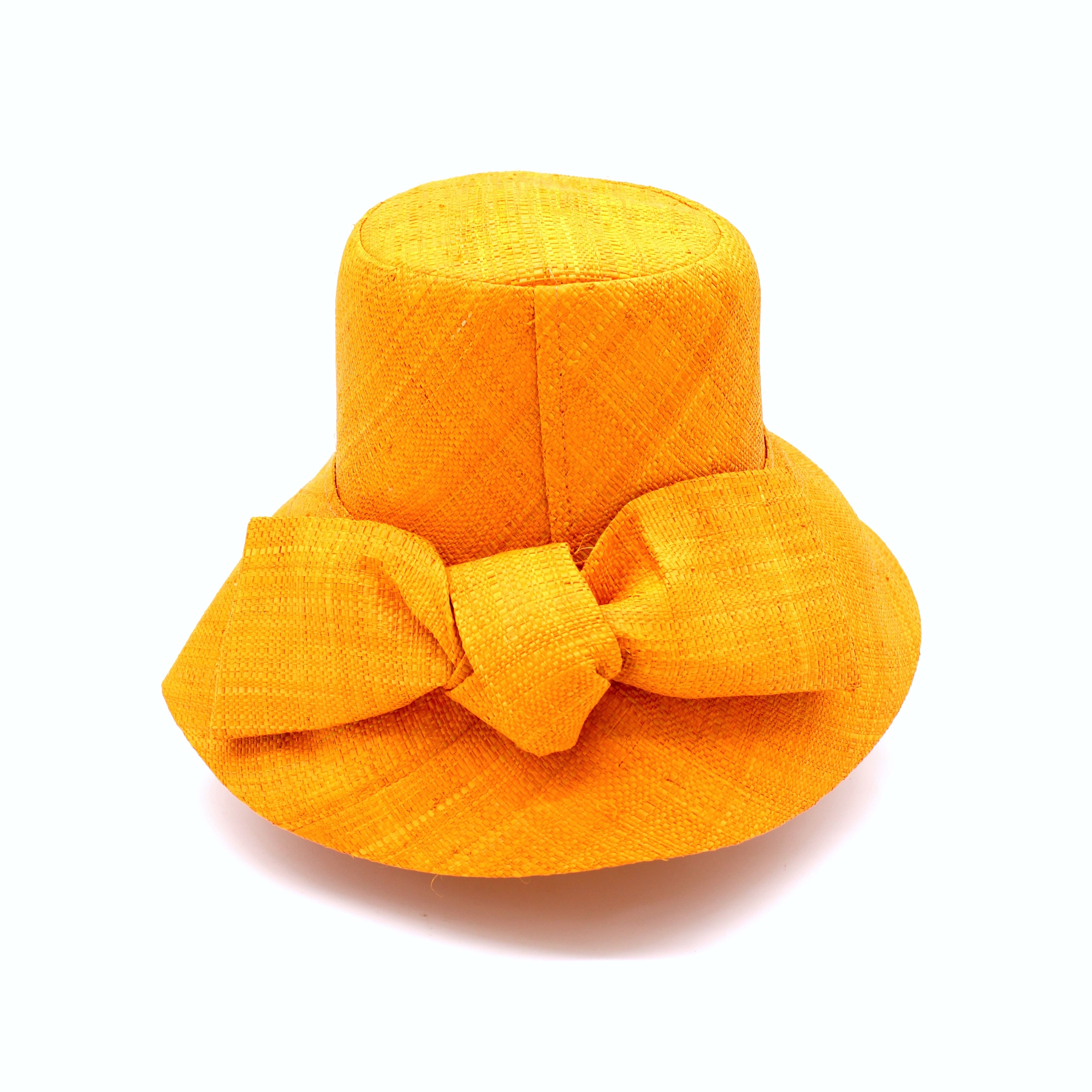 Cara Saffron big bow embellishment handmade loomed raffia in a solid hue of saffron yellow/orange straw bucket style cloche sun hat with matching oversized bow - Shebobo