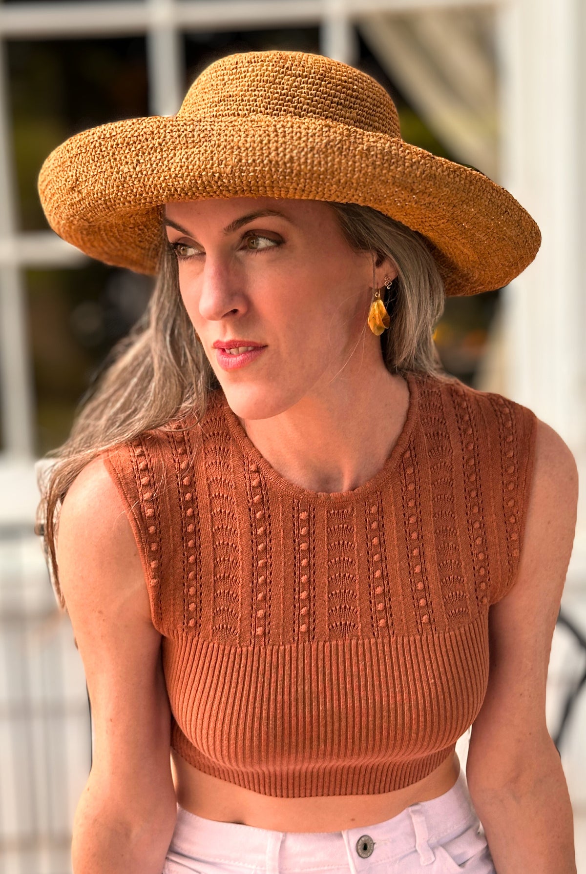 Model wearing Leor crochet straw hat handmade Blush orange/pink color raffia 3" brim packable straw hat with matching adjustable band - Shebobo