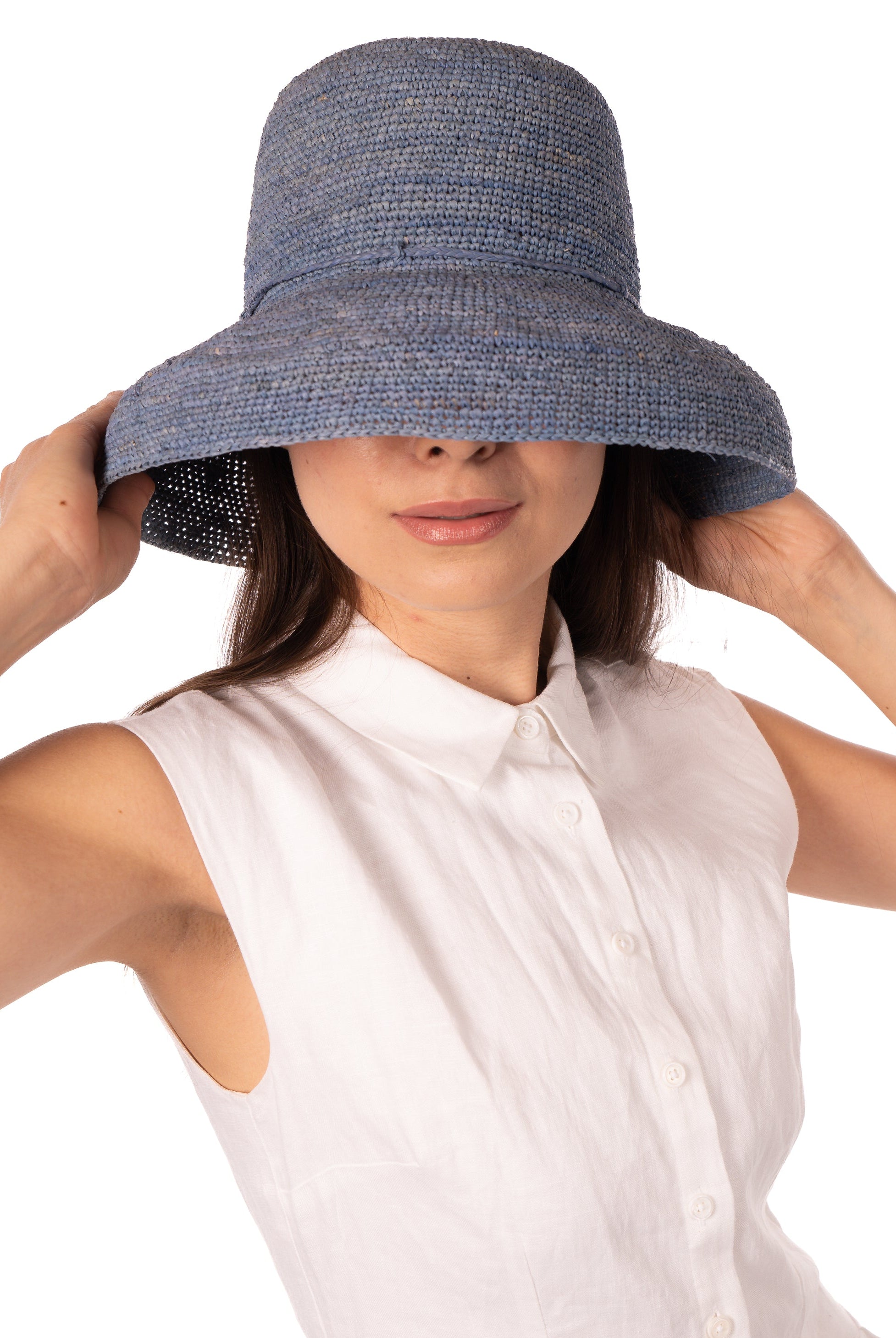 Model wearing Leor Denim crochet straw hat handmade woven natural raffia palm fiber in a solid hue of denim/retro/light/blue color 3" brim packable straw hat with matching adjustable braided hat band - Shebobo