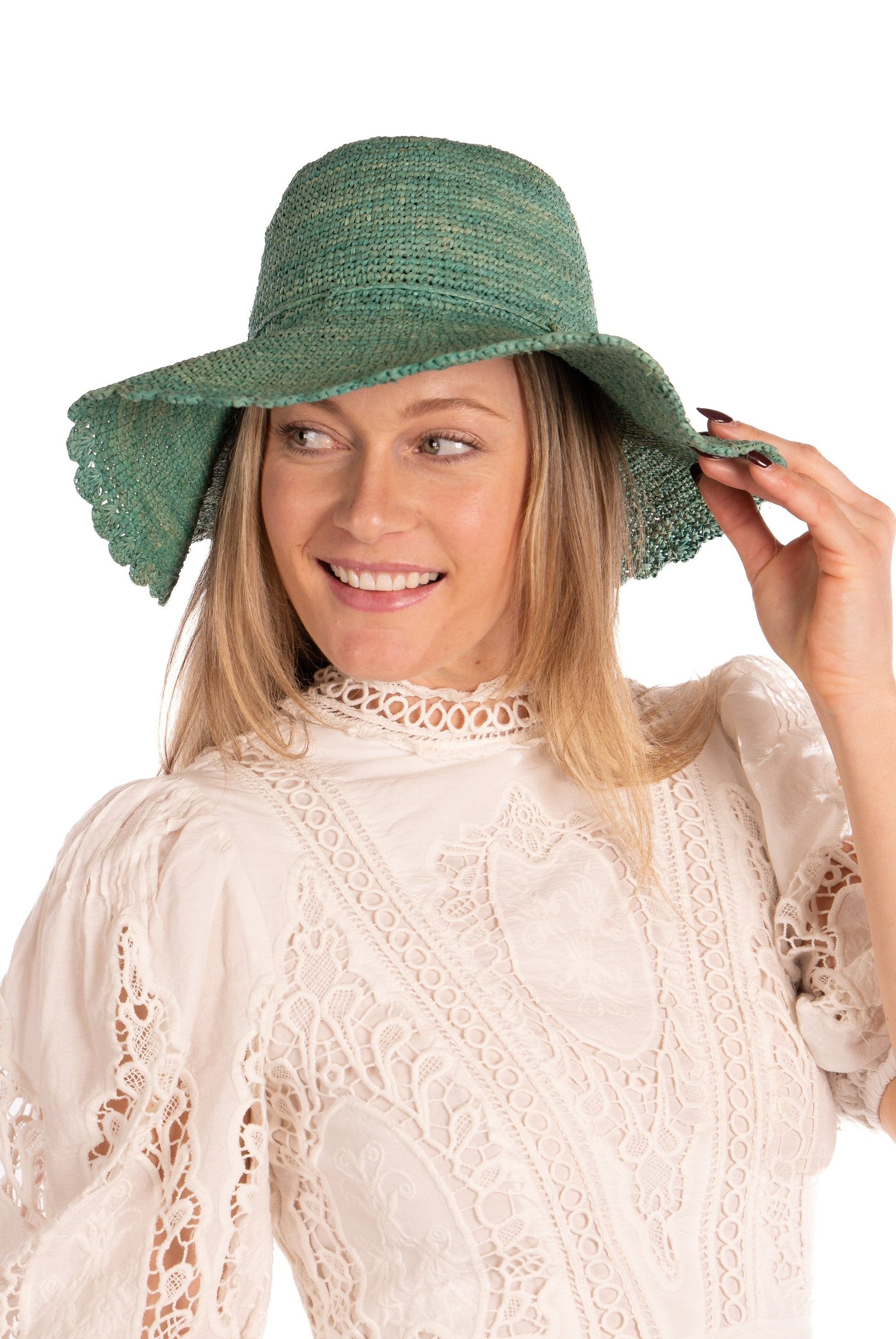 Model wearing 4" Brim Genevieve Seafoam Crochet Straw Sun Hat with Lace Weave Edge handmade raffia palm fiber crochet solid hue seafoam blue/green rounded crown with detailed lace weave edge and matching adjustable hat band - Shebobo