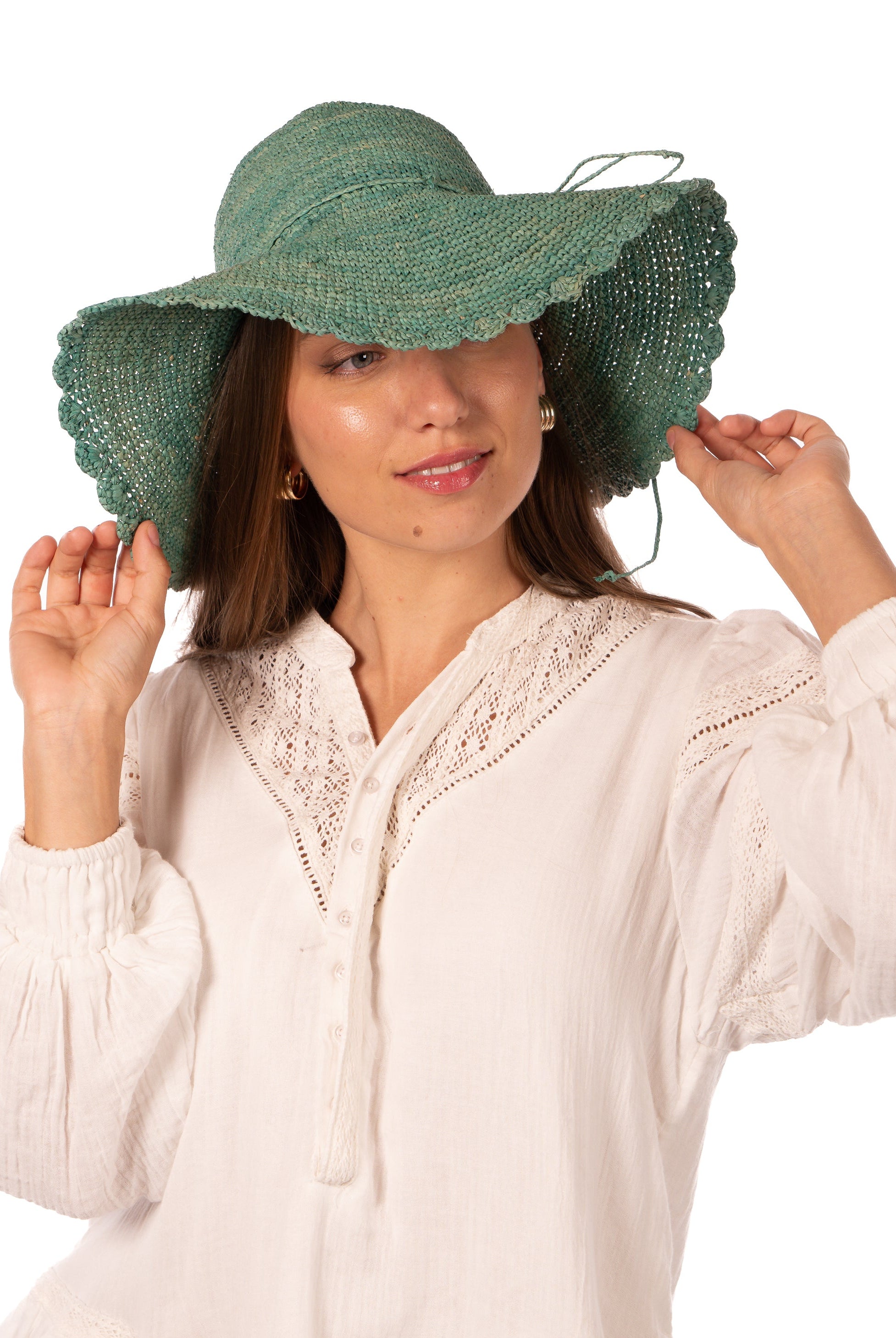 Model wearing 4" Brim Genevieve Seafoam Crochet Straw Sun Hat with Lace Weave Edge handmade raffia palm fiber crochet solid hue seafoam blue/green rounded crown with detailed lace weave edge and matching adjustable hat band - Shebobo