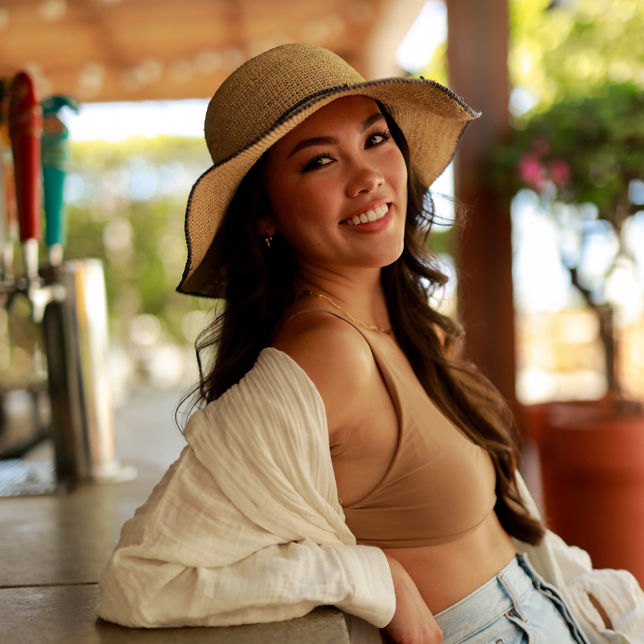 Model wearing 4 inch brim Rachel Crochet grey handmade straw sun hat grey trim woven edge and matching adjustable hat band on natural straw colored raffia hat - Shebobo