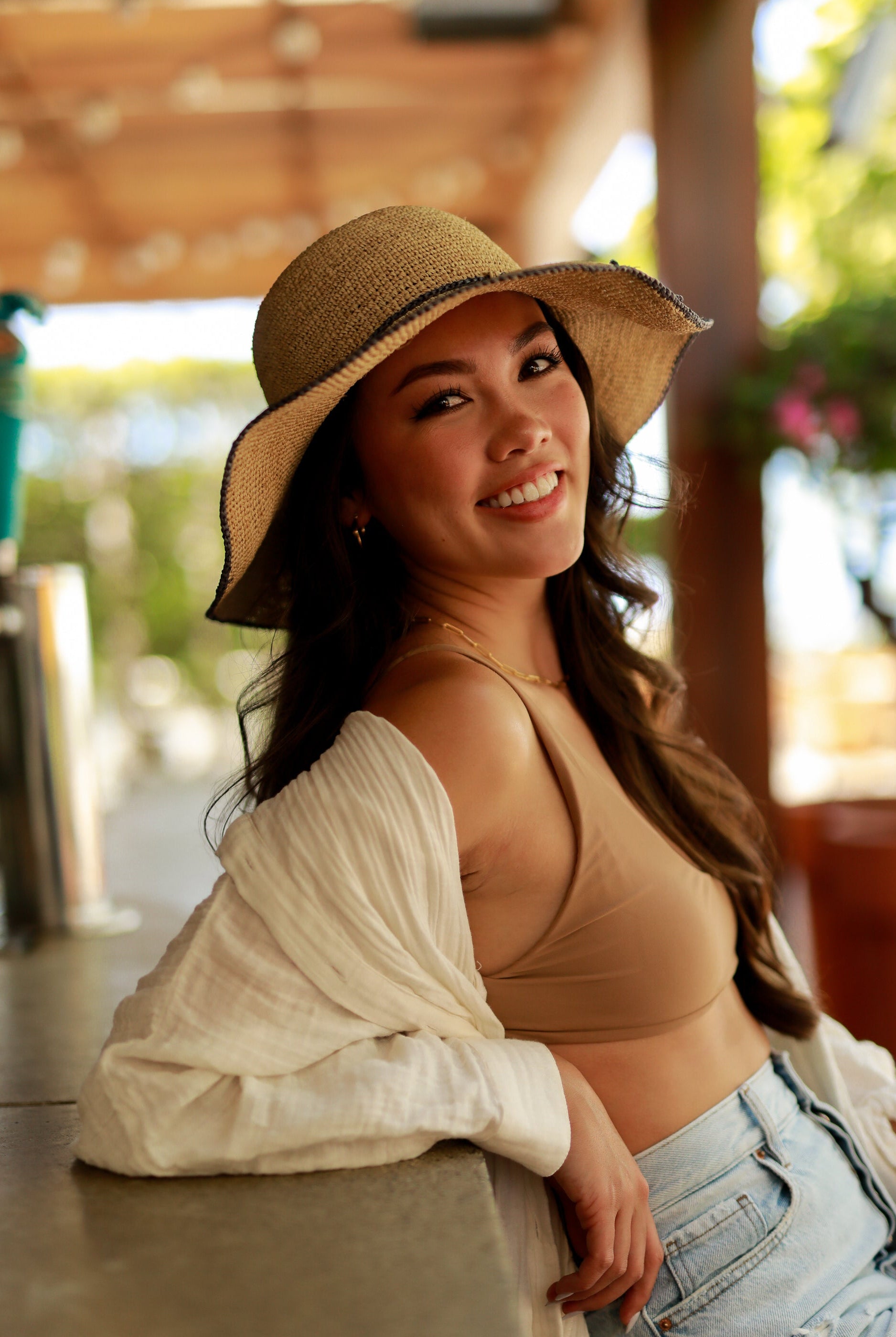 Model wearing 4 inch brim Rachel Crochet grey handmade straw sun hat grey trim woven edge and matching adjustable hat band on natural straw colored raffia hat - Shebobo