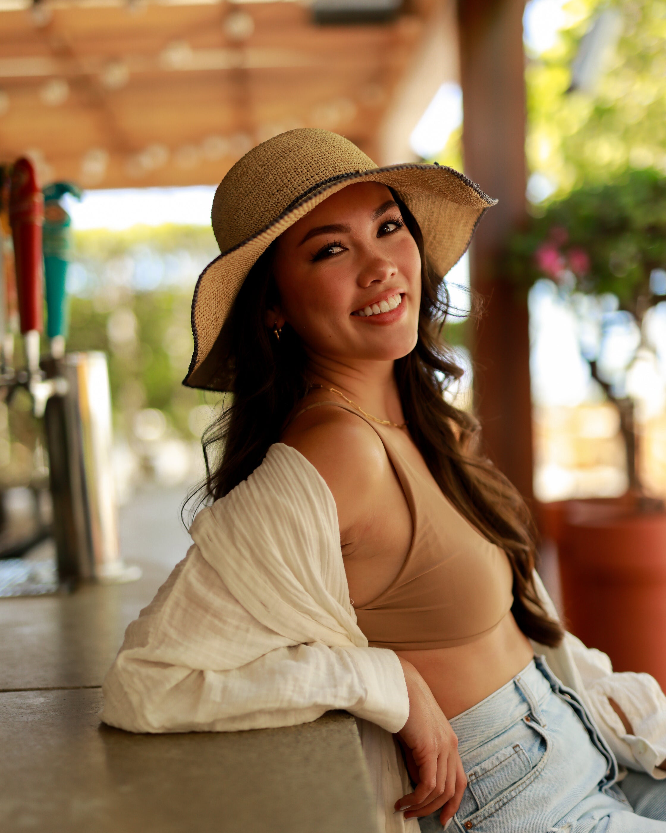 Model wearing 4 inch brim Rachel Crochet grey handmade straw sun hat grey trim woven edge and matching adjustable hat band on natural straw colored raffia hat - Shebobo