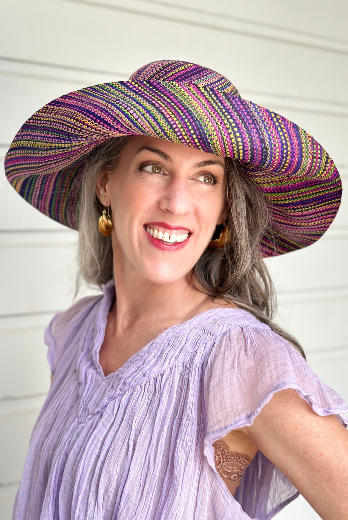 Model wearing 5" & 7" Wide Brim Orchid Multi Melange Packable Straw Sun Hat multicolor heather pattern of orchid purple, fuchsia pink, navy blue, green, yellow, pink, black, etc. - Shebobo