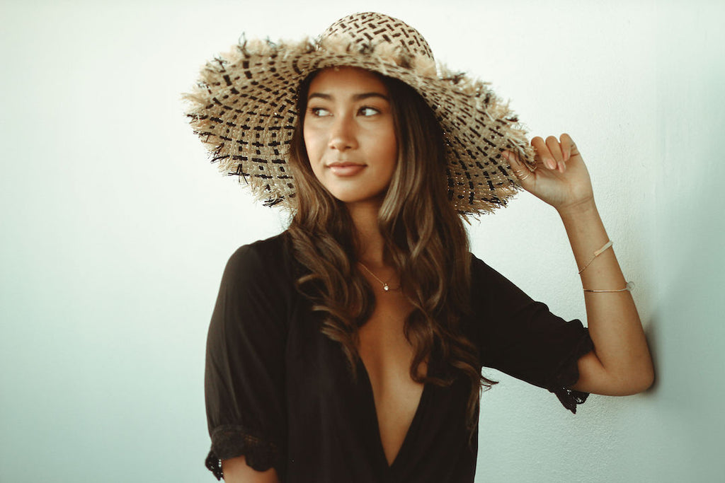 Model wearing 5" Brim Kat Black Two Tone Multicolor Straw Sun Hats with Raw Fringe Edge handmade woven raffia in a crosshatch pattern of black and natural straw color with wide brim and hand brushed edge embellishment - Shebobo