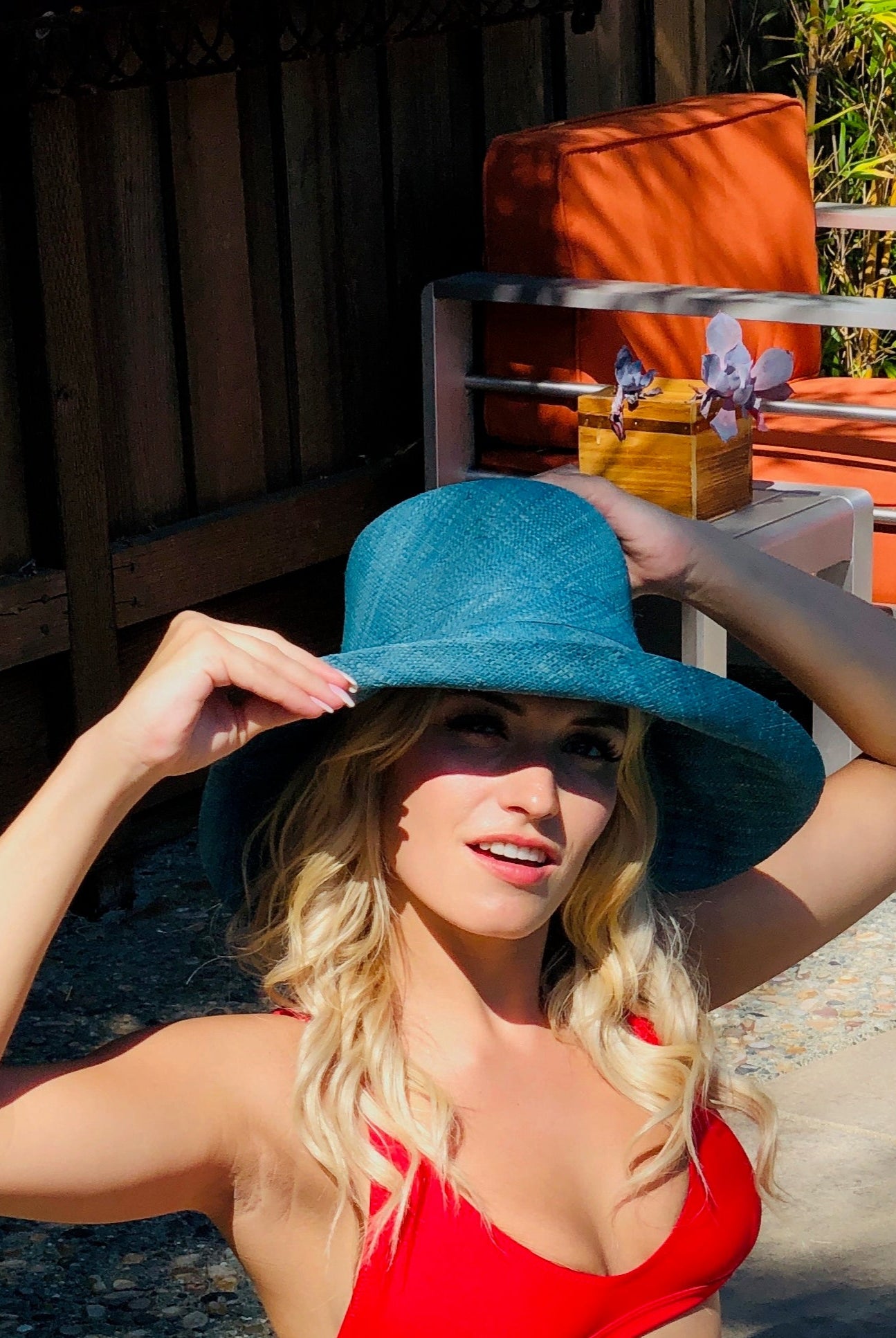 Model wearing 5" Wide Brim Turquoise Packable Straw Sun Hat handmade loomed raffia in a solid hue of turquoise blue lightweight malleable flexible sun protection hat - Shebobo