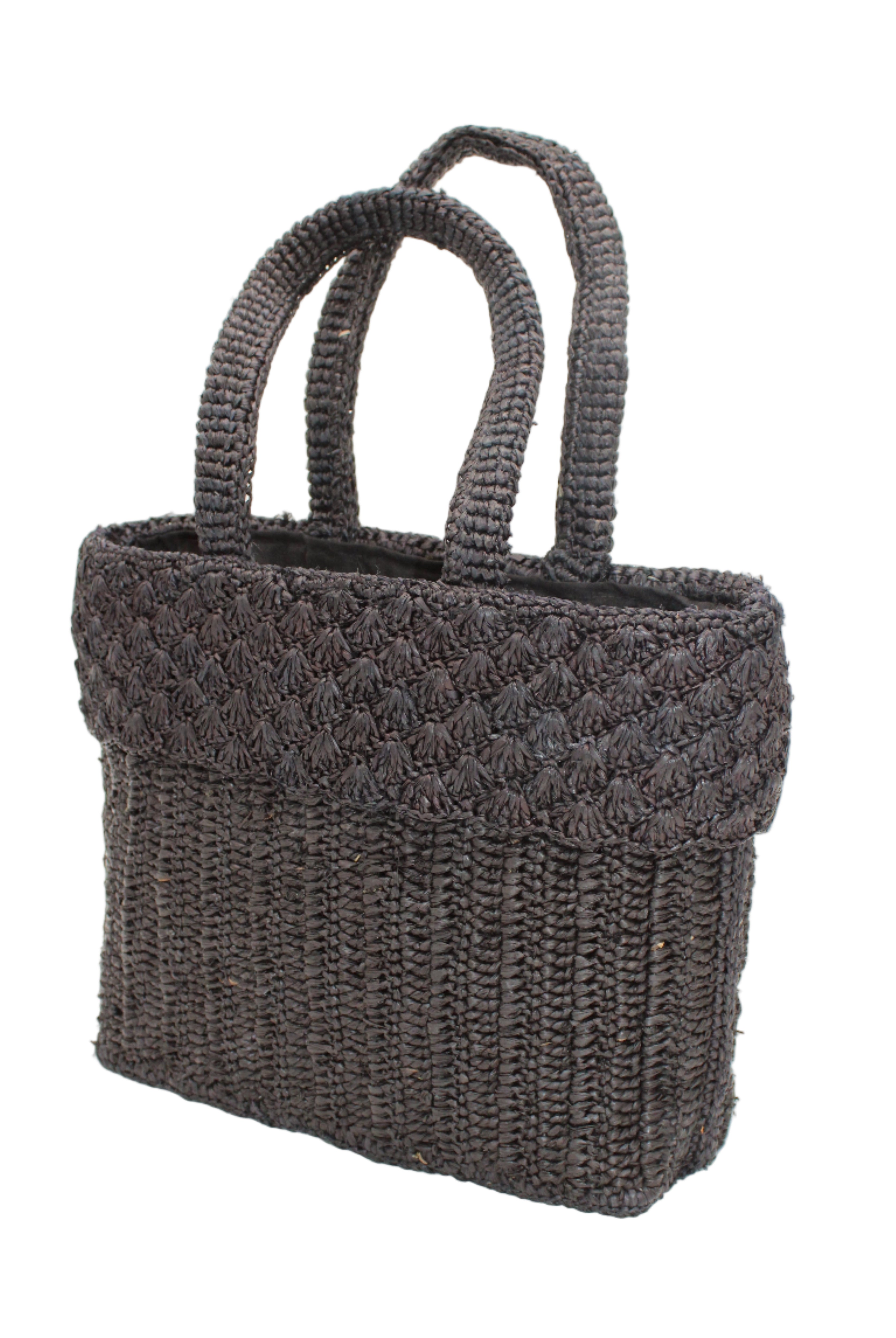 Side view Anna Petal Pattern Crochet Straw Basket Handbag handmade natural raffia palm fiber in a solid hue of Black crochet in multiple textures resulting in a subtle pattern of vertical linked bands on the bottom 2/3 of the bag, and a floral petal or shell pattern on the upper third with rolled panel of links making up the handles Beach Bag Purse - Shebobo