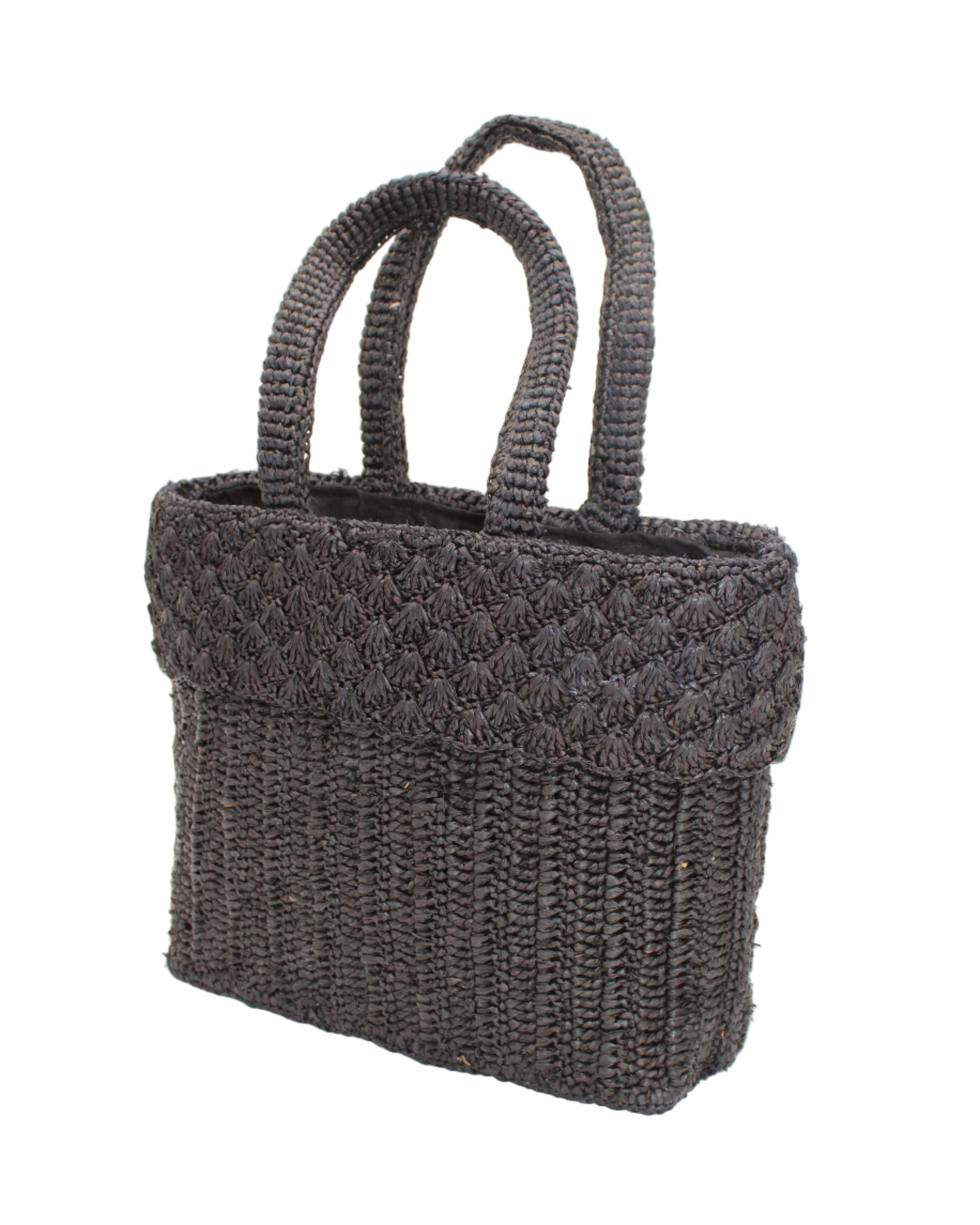 Side view Anna Petal Pattern Crochet Straw Basket Handbag handmade natural raffia palm fiber in a solid hue of Black crochet in multiple textures resulting in a subtle pattern of vertical linked bands on the bottom 2/3 of the bag, and a floral petal or shell pattern on the upper third with rolled panel of links making up the handles Beach Bag Purse - Shebobo
