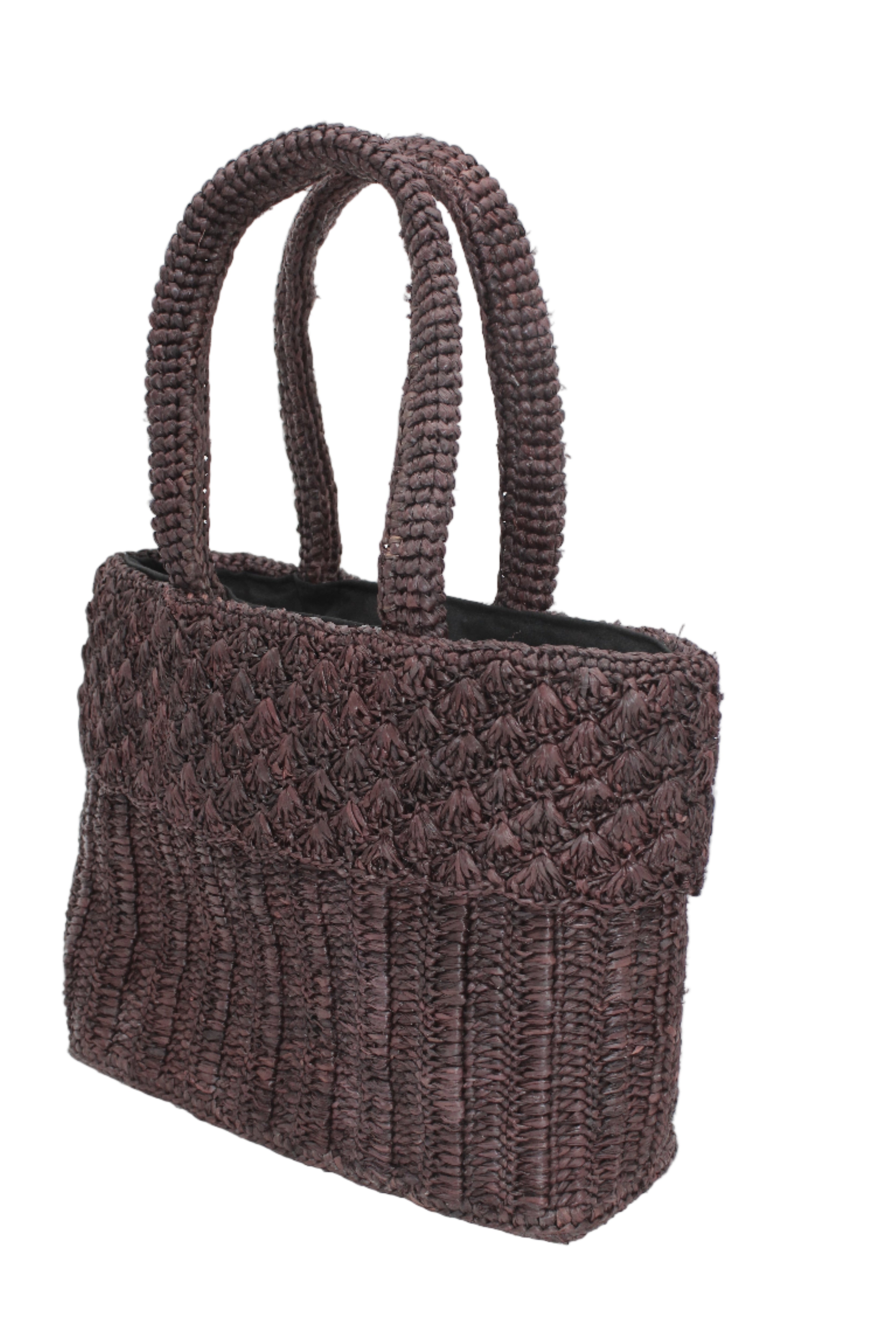 Side view Anna Petal Pattern Crochet Straw Basket Handbag handmade natural raffia palm fiber in a solid hue of Mocha chocolate/dark/brown crochet in multiple textures resulting in a subtle pattern of vertical linked bands on the bottom 2/3 of the bag, and a floral petal or shell pattern on the upper third with rolled panel of links making up the handles Beach Bag Purse - Shebobo