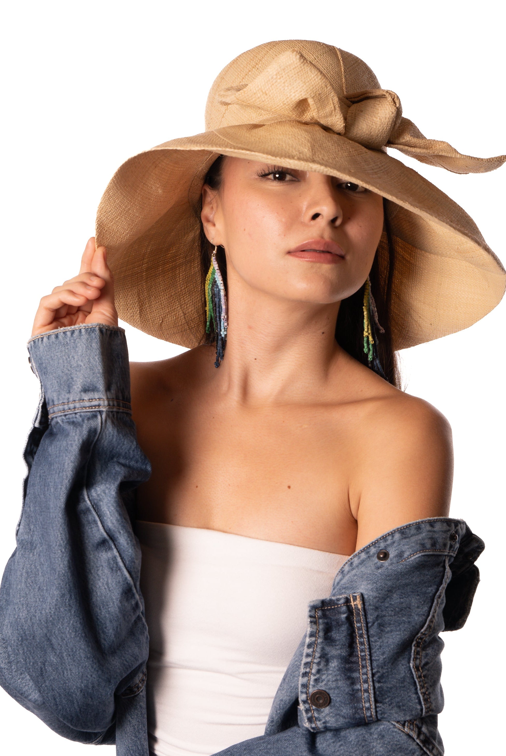 Model wearing Audrey 5" Wide Brim Solid Color Straw Sun Hats with Big Bow handmade loomed natural raffia straw fiber in a solid hue of natural straw color with matching oversized big bow embellishment hat band - Shebobo