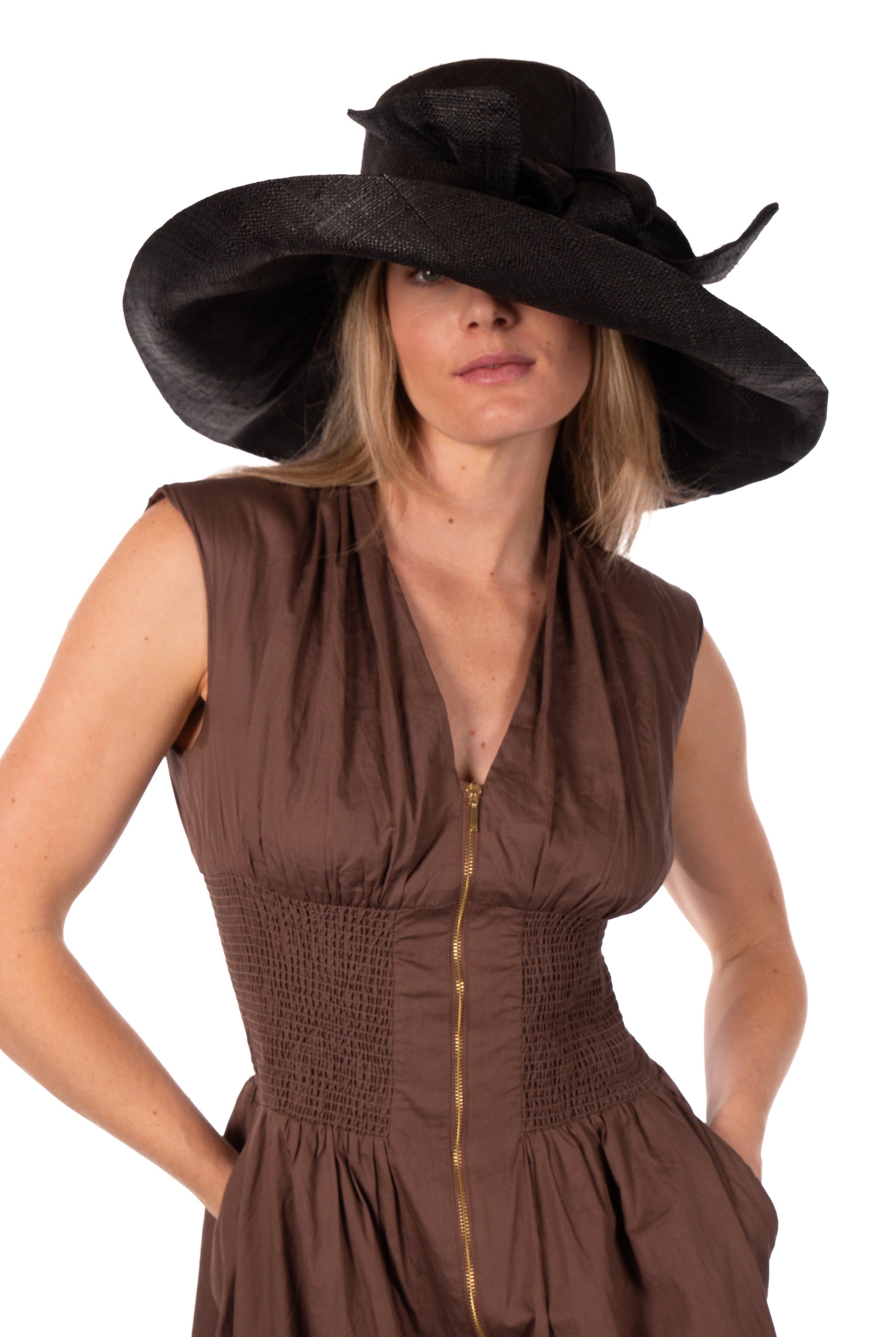 Model wearing Audrey 7" Wide Brim Solid Color Straw Sun Hats with Big Bow handmade loomed natural raffia straw fiber in a solid hue of black with matching oversized big bow embellishment hat band - Shebobo