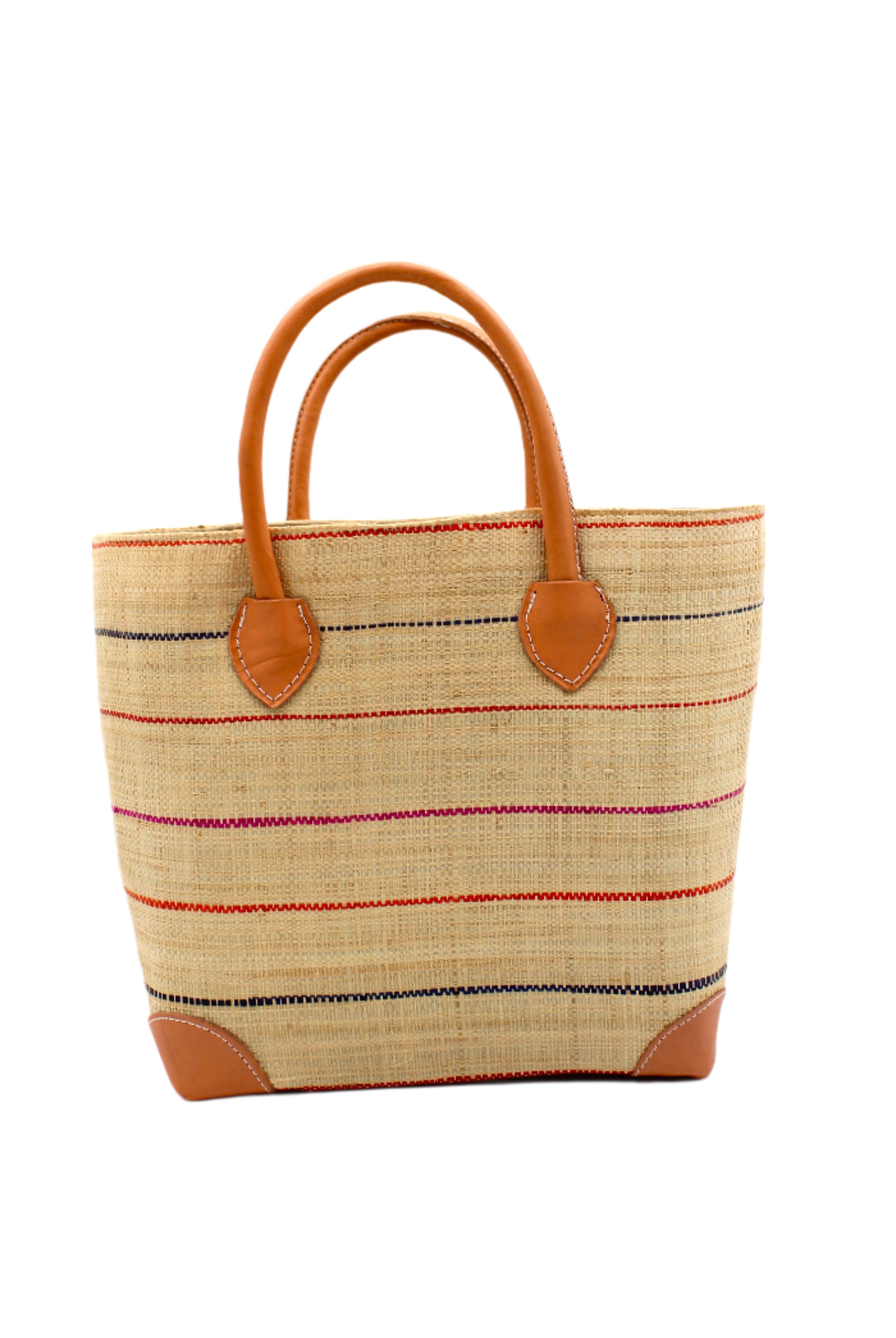 Augustine pinstripes straw basket bag handmade loomed raffia in natural wide horizontal bands with multicolor coral red/orange, fuchsia pink, and navy blue small bands running through in a stripe pattern with leather accents and handles handbag purse - Shebobo