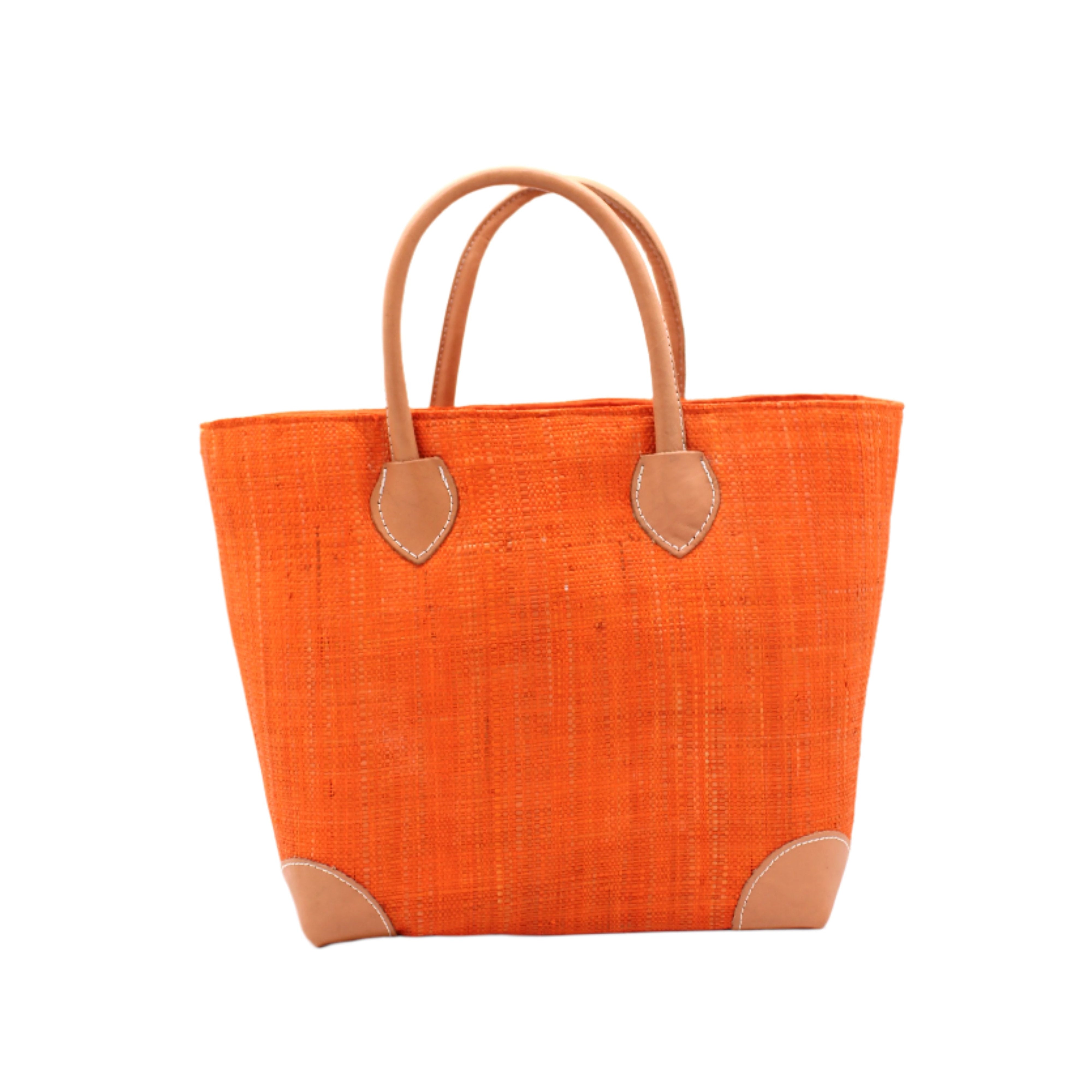 Augustine Straw Basket Bag Coral handmade loomed raffia palm fiber in a solid hue of coral orange/red handbag purse with leather accents and handles beach bag - Shebobo