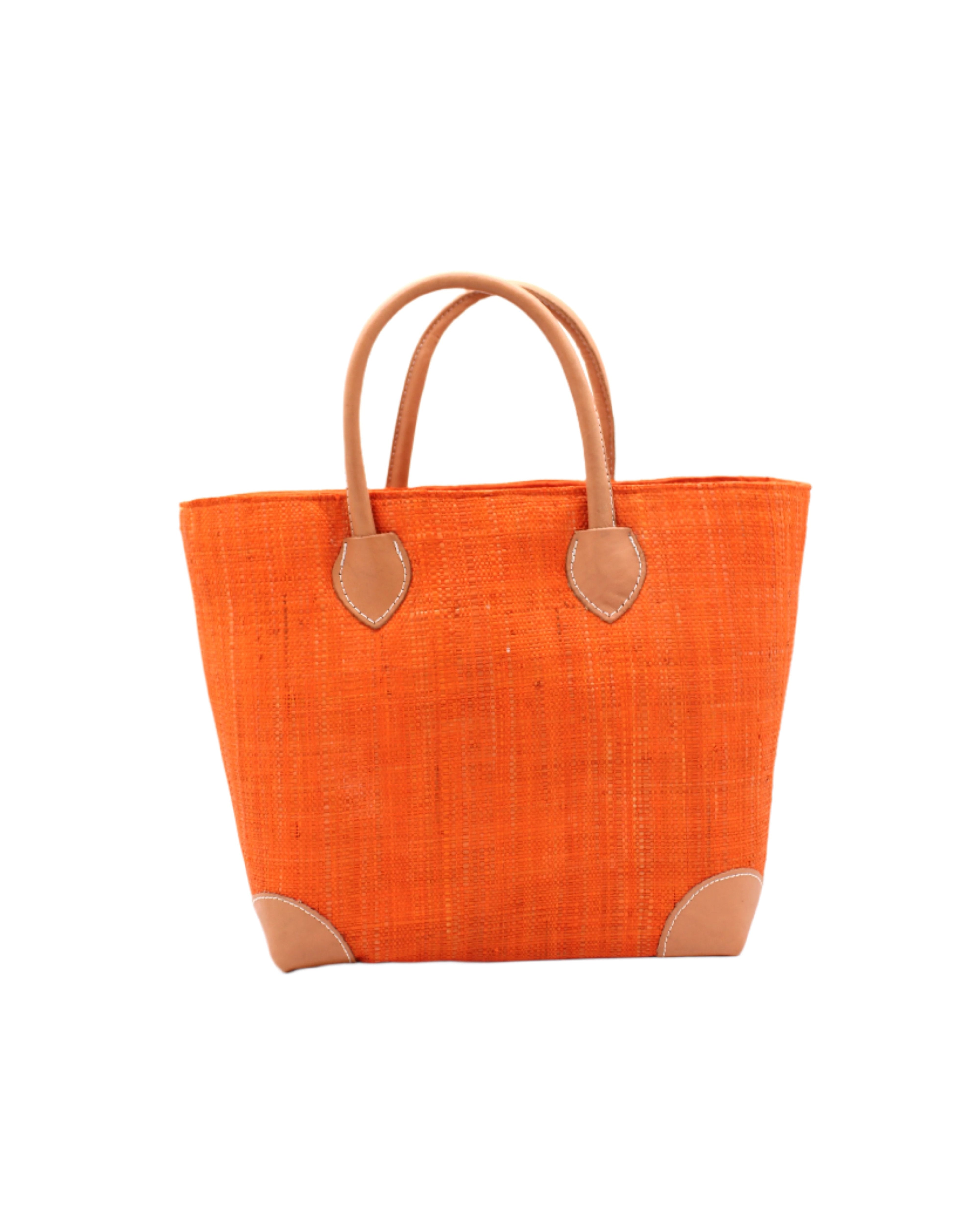 Augustine Straw Basket Bag Coral handmade loomed raffia palm fiber in a solid hue of coral orange/red handbag purse with leather accents and handles beach bag - Shebobo