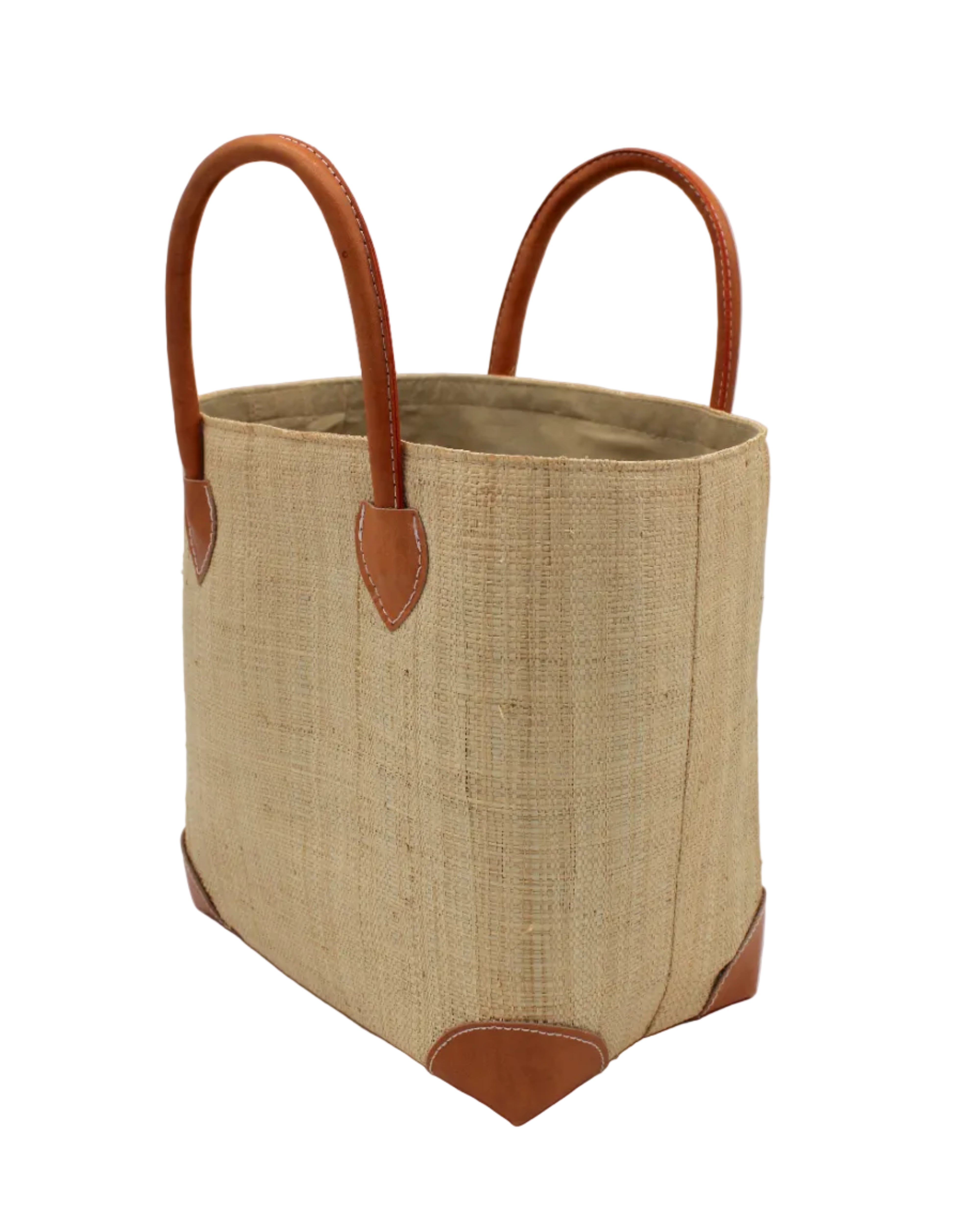 Side view Augustine Straw Basket Bag Natural handmade loomed raffia palm fiber in a solid hue of natural straw color handbag purse with leather accents and handles beach bag - Shebobo