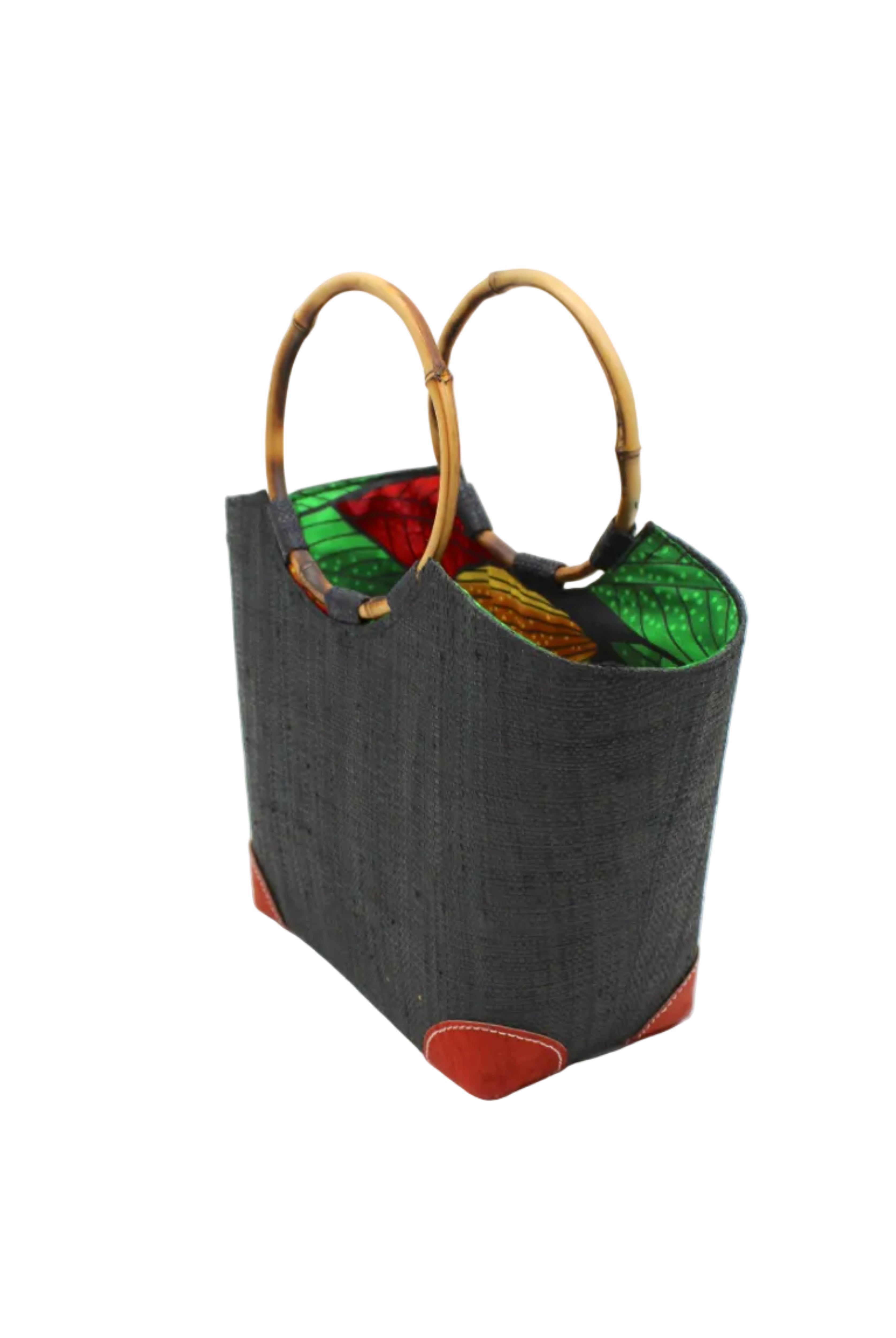 Side view Betty Straw Bucket Bag with Bamboo Handles handmade loomed natural raffia palm fiber in a solid hue of black with circular bamboo handles, leather feet, and colorful African Print wax cloth liner handbag purse tote - Shebobo