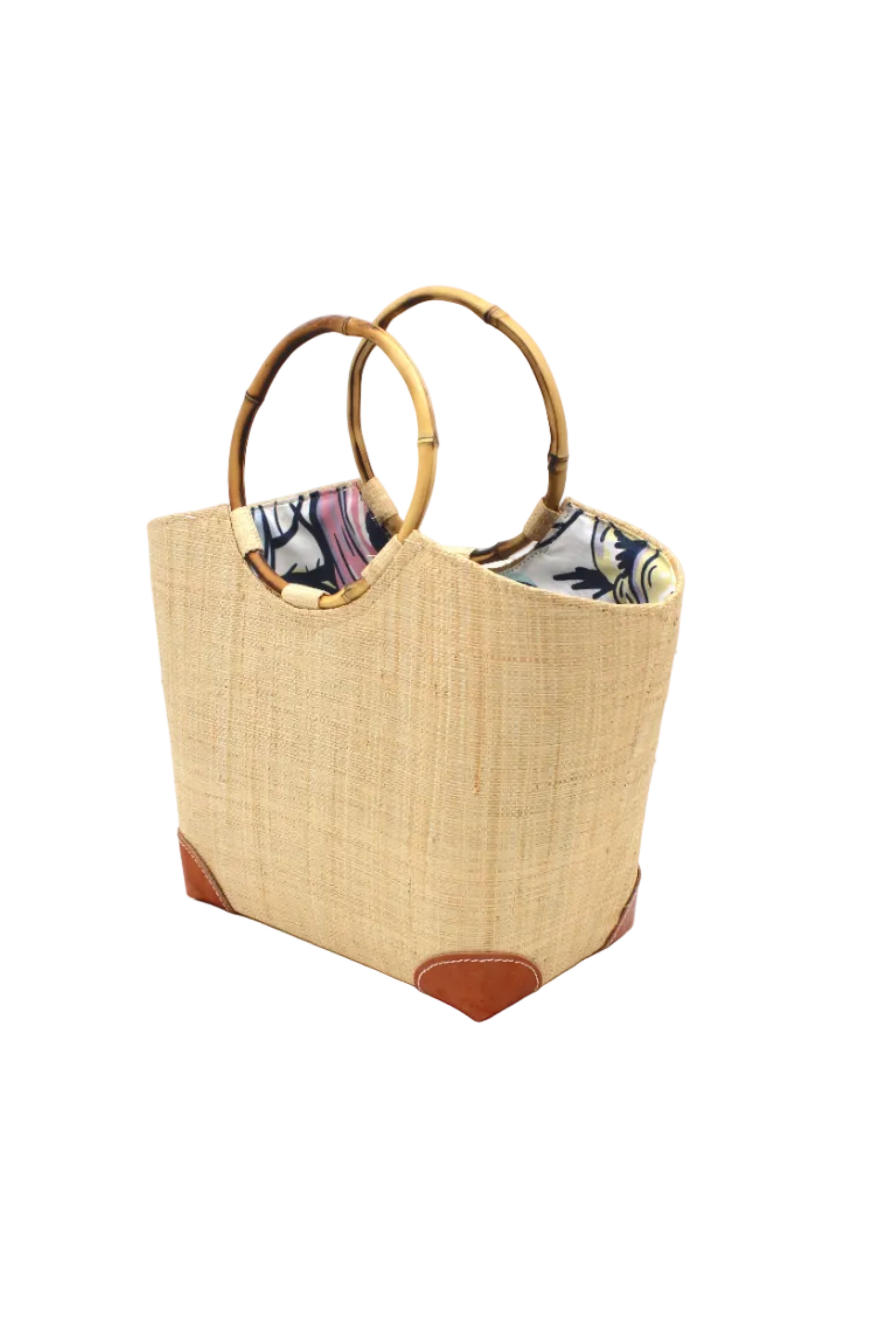 Side view Betty Straw Bucket Bag with Bamboo Handles handmade loomed natural raffia palm fiber in a solid hue of natural straw color with circular bamboo handles, leather feet, and colorful African Print wax cloth liner handbag purse tote - Shebobo