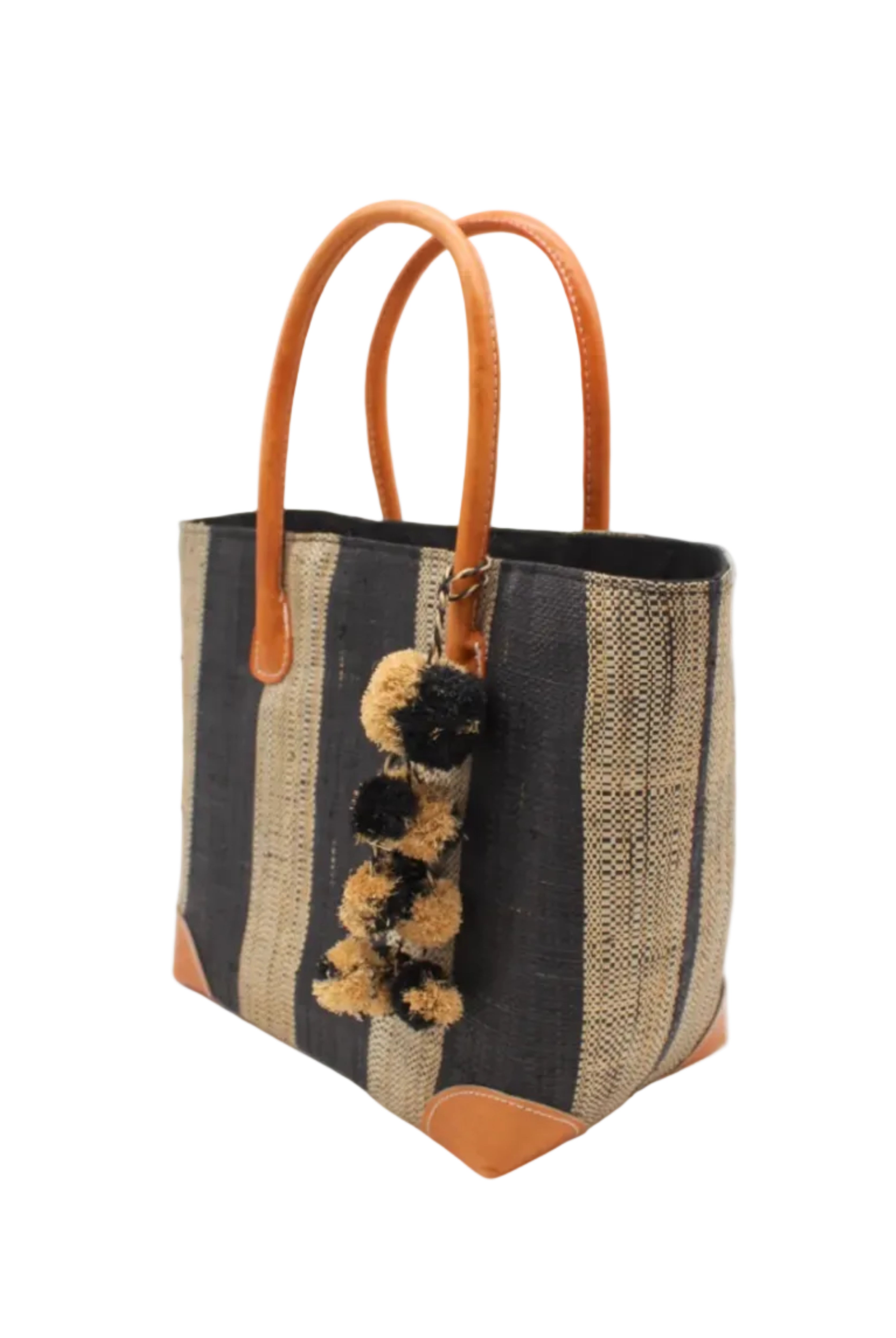 Side view Bora Bora Black Two Tone Stripes Straw Basket Bag with Waterfall Pompoms Charm Embellishment handmade loomed natural raffia palm fiber in a multicolor horizontal stripe pattern of even width wide bands of black and natural straw color with leather handles and feet plus matching waterfall pompom charm embellishment handbag beach bag - Shebobo