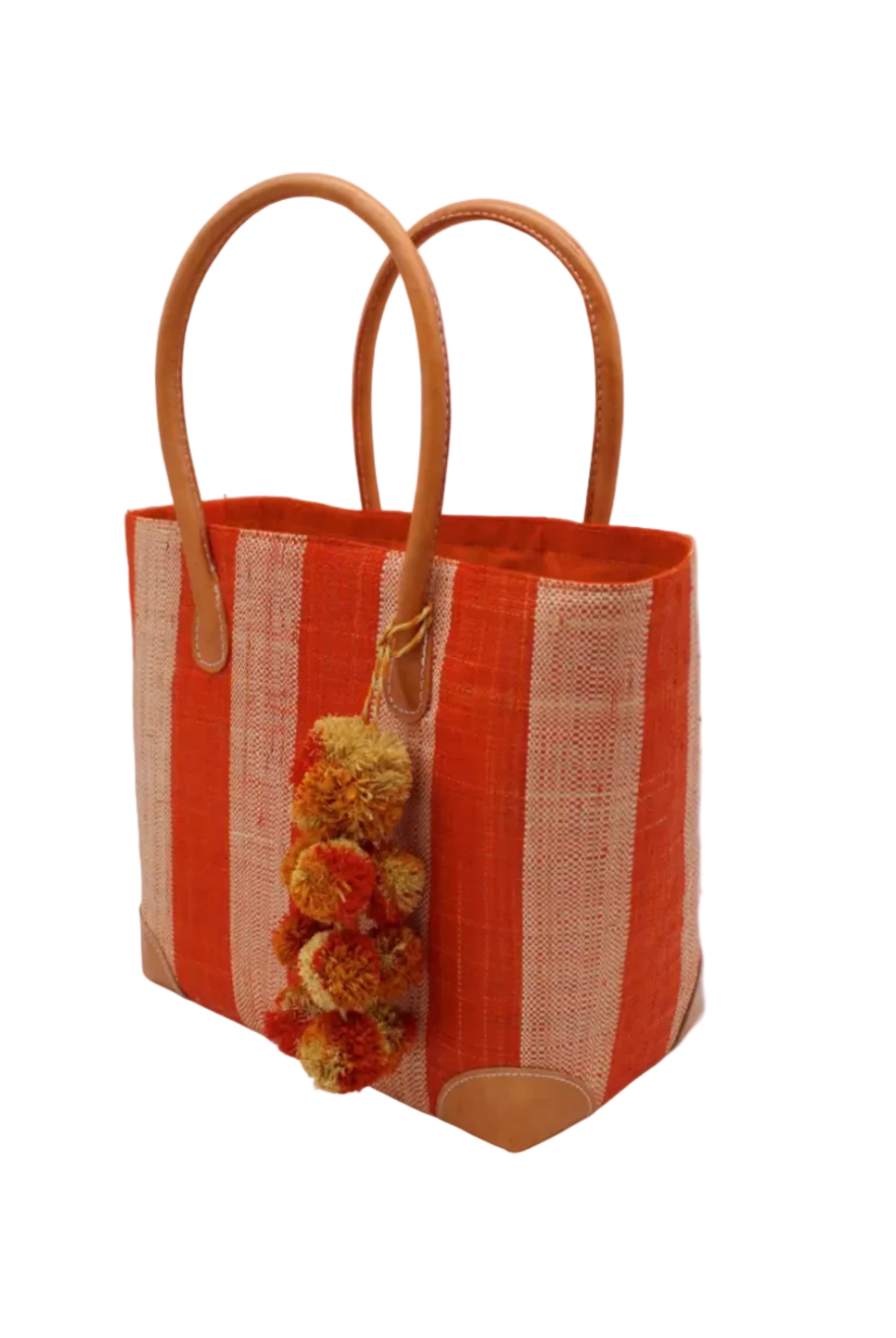 Side view Bora Bora Coral Two Tone Stripes Straw Basket Bag with Waterfall Pompoms Charm Embellishment handmade loomed natural raffia palm fiber in a multicolor horizontal stripe pattern of even width wide bands of coral orange/red and natural straw color with leather handles and feet plus matching waterfall pompom charm embellishment handbag beach bag - Shebobo