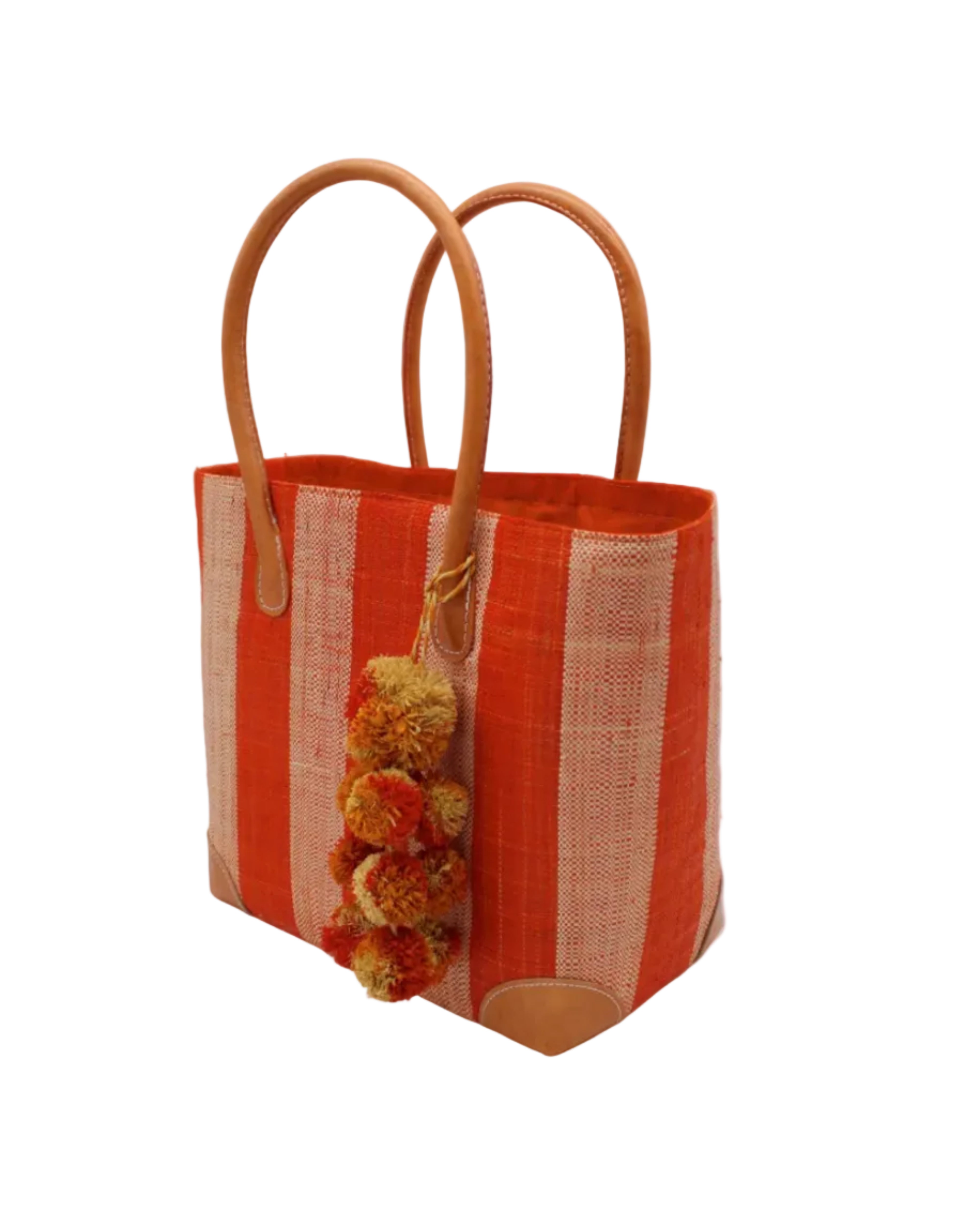 Side view Bora Bora Coral Two Tone Stripes Straw Basket Bag with Waterfall Pompoms Charm Embellishment handmade loomed natural raffia palm fiber in a multicolor horizontal stripe pattern of even width wide bands of coral orange/red and natural straw color with leather handles and feet plus matching waterfall pompom charm embellishment handbag beach bag - Shebobo