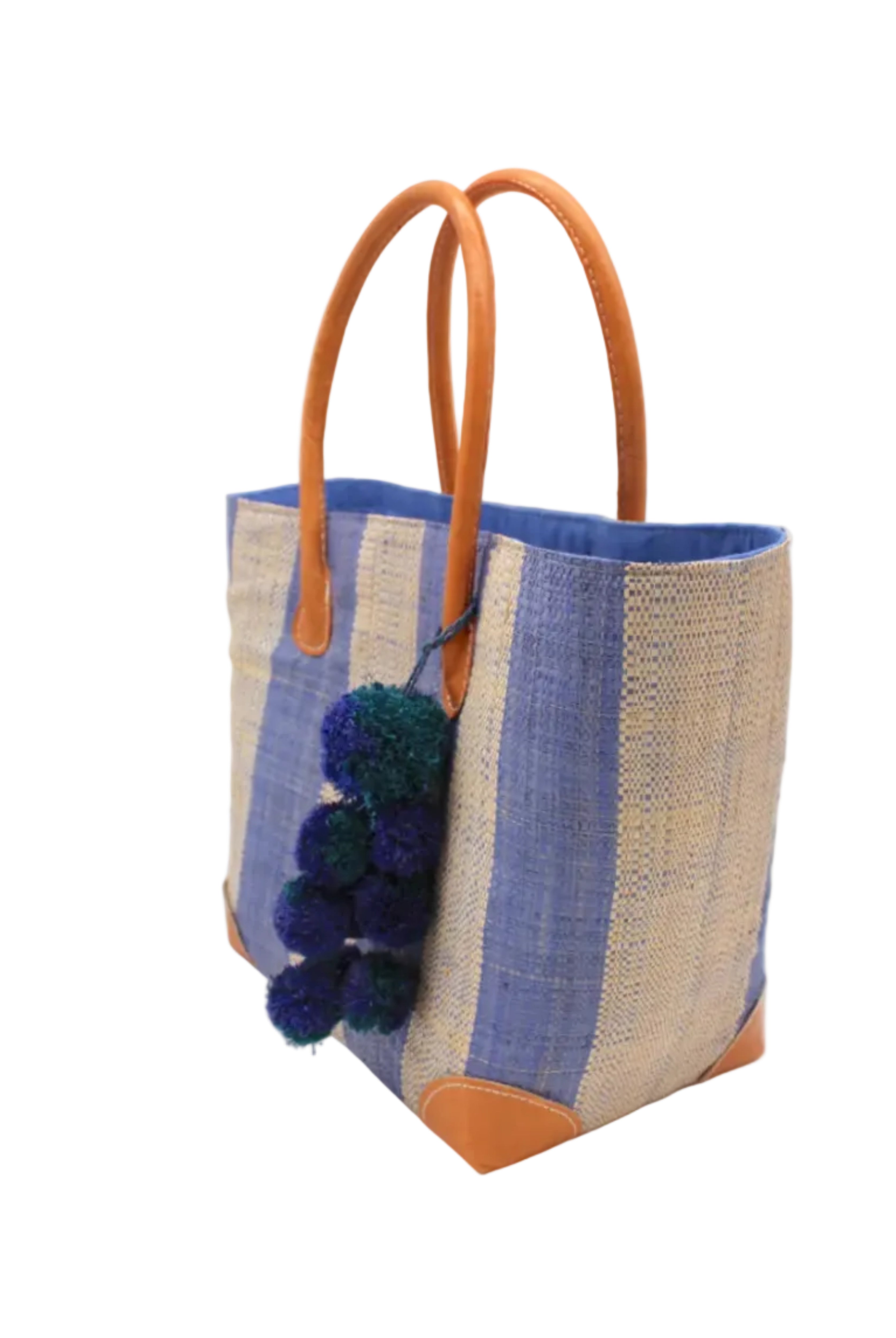 Side view Bora Bora Denim Two Tone Stripes Straw Basket Bag with Waterfall Pompoms Charm Embellishment handmade loomed natural raffia palm fiber in a multicolor horizontal stripe pattern of even width wide bands of denim retro/light/blue and natural straw color with leather handles and feet plus matching waterfall pompom charm embellishment handbag beach bag - Shebobo