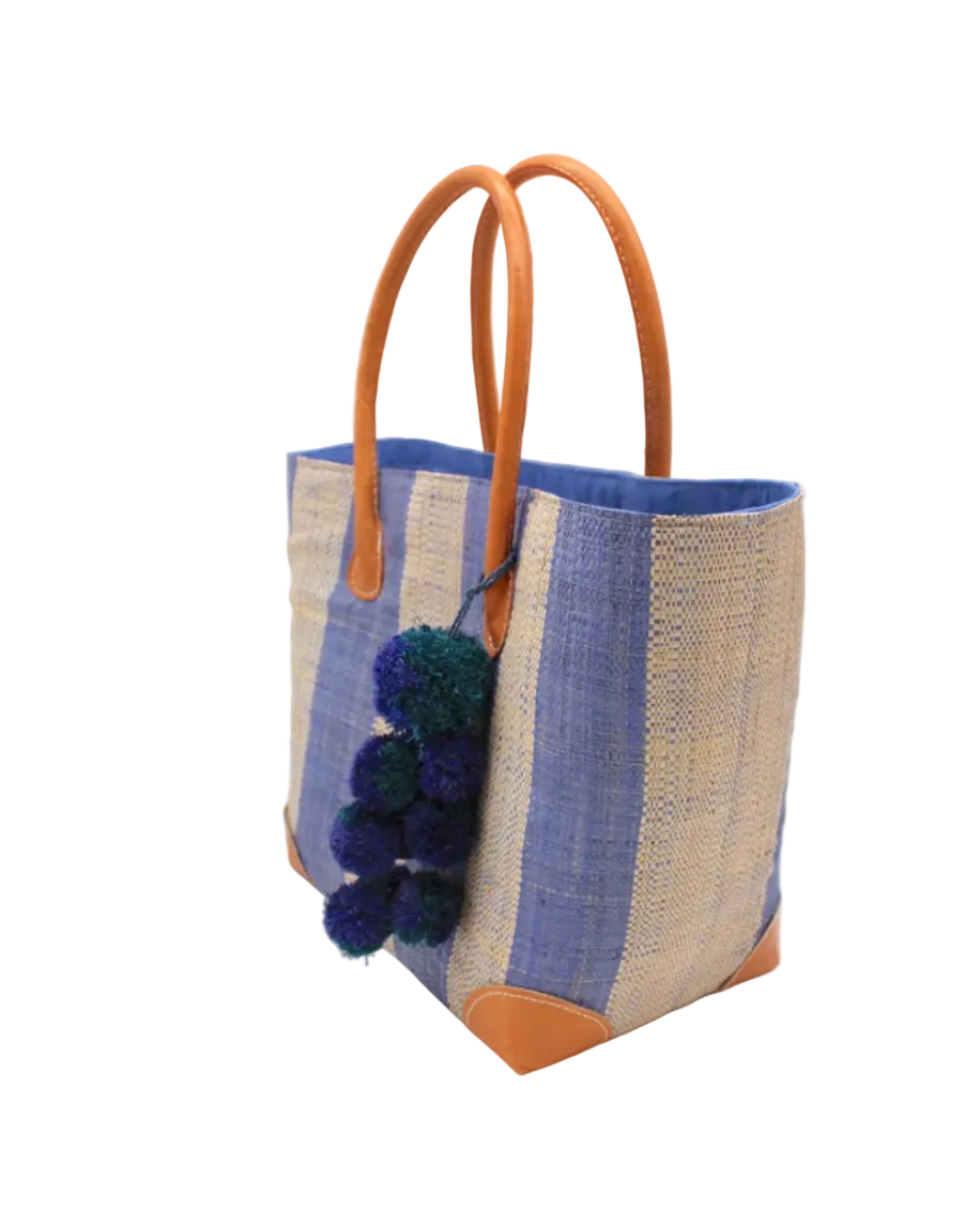 Side view Bora Bora Denim Two Tone Stripes Straw Basket Bag with Waterfall Pompoms Charm Embellishment handmade loomed natural raffia palm fiber in a multicolor horizontal stripe pattern of even width wide bands of denim retro/light/blue and natural straw color with leather handles and feet plus matching waterfall pompom charm embellishment handbag beach bag - Shebobo