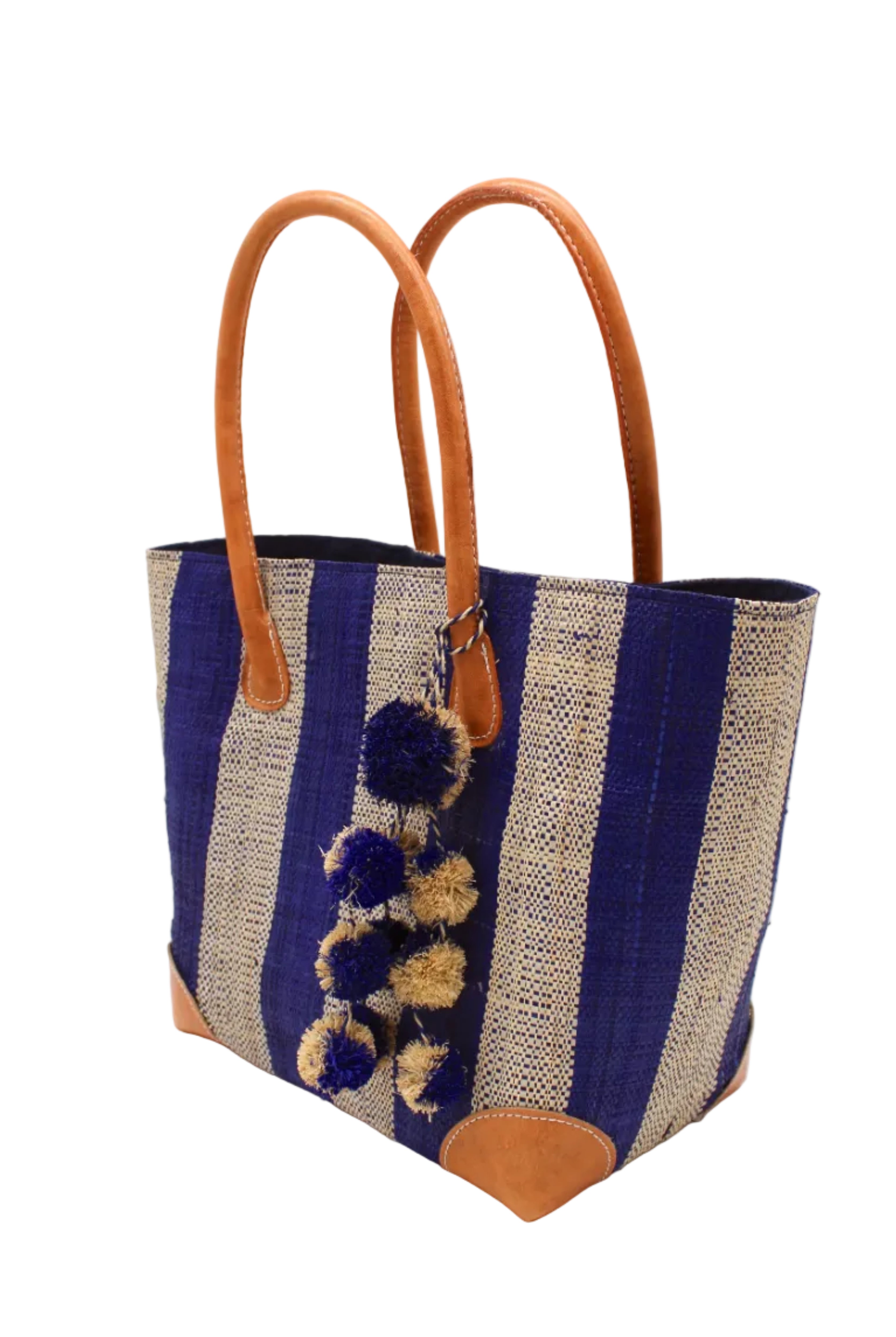 Side view Bora Bora Dusk Two Tone Stripes Straw Basket Bag with Waterfall Pompoms Charm Embellishment handmade loomed natural raffia palm fiber in a multicolor horizontal stripe pattern of even width wide bands of dusk navy/dark/blue and natural straw color with leather handles and feet plus matching waterfall pompom charm embellishment handbag beach bag - Shebobo