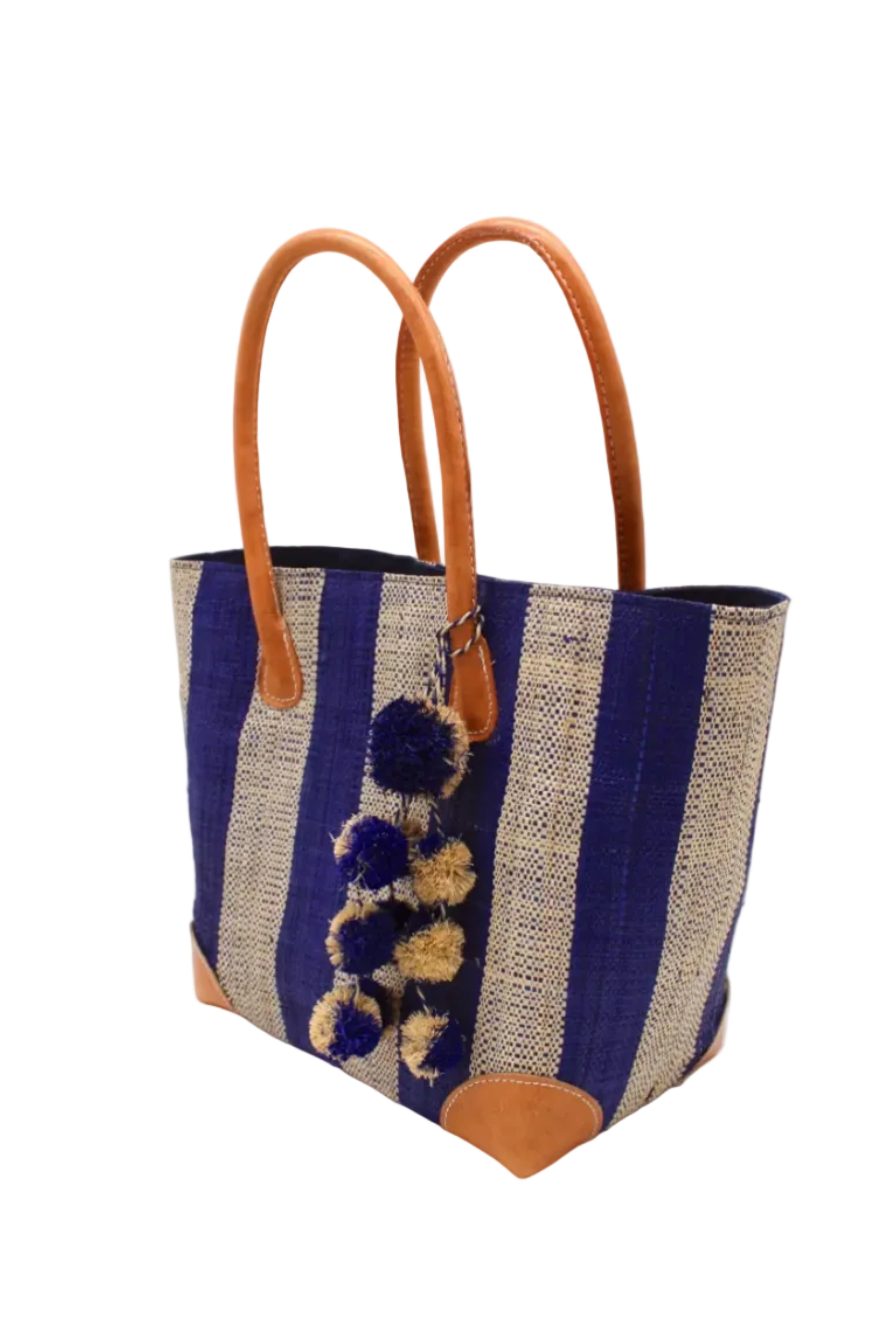 Side view Bora Bora Dusk Two Tone Stripes Straw Basket Bag with Waterfall Pompoms Charm Embellishment handmade loomed natural raffia palm fiber in a multicolor horizontal stripe pattern of even width wide bands of dusk navy/dark/blue and natural straw color with leather handles and feet plus matching waterfall pompom charm embellishment handbag beach bag - Shebobo