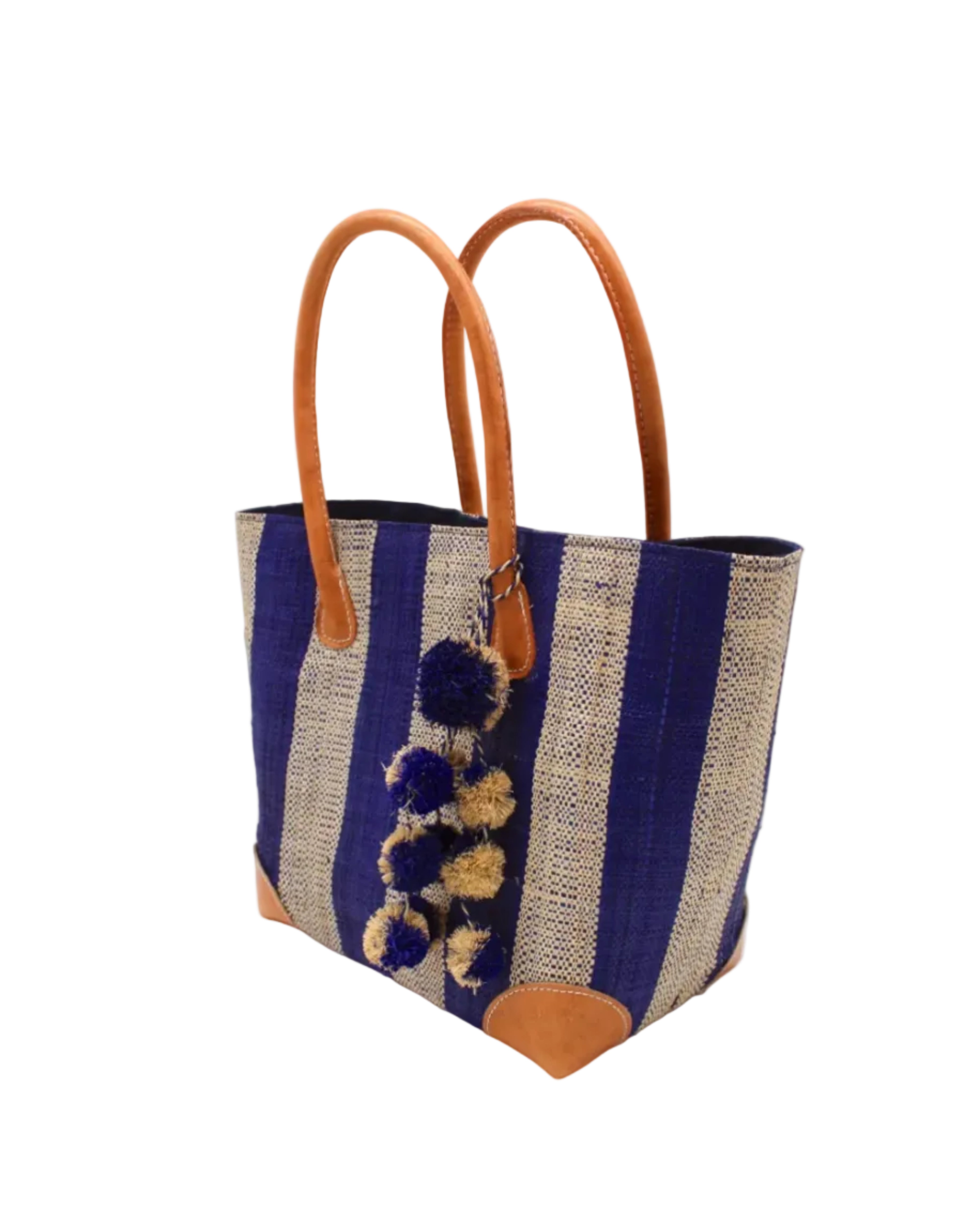 Side view Bora Bora Dusk Two Tone Stripes Straw Basket Bag with Waterfall Pompoms Charm Embellishment handmade loomed natural raffia palm fiber in a multicolor horizontal stripe pattern of even width wide bands of dusk navy/dark/blue and natural straw color with leather handles and feet plus matching waterfall pompom charm embellishment handbag beach bag - Shebobo