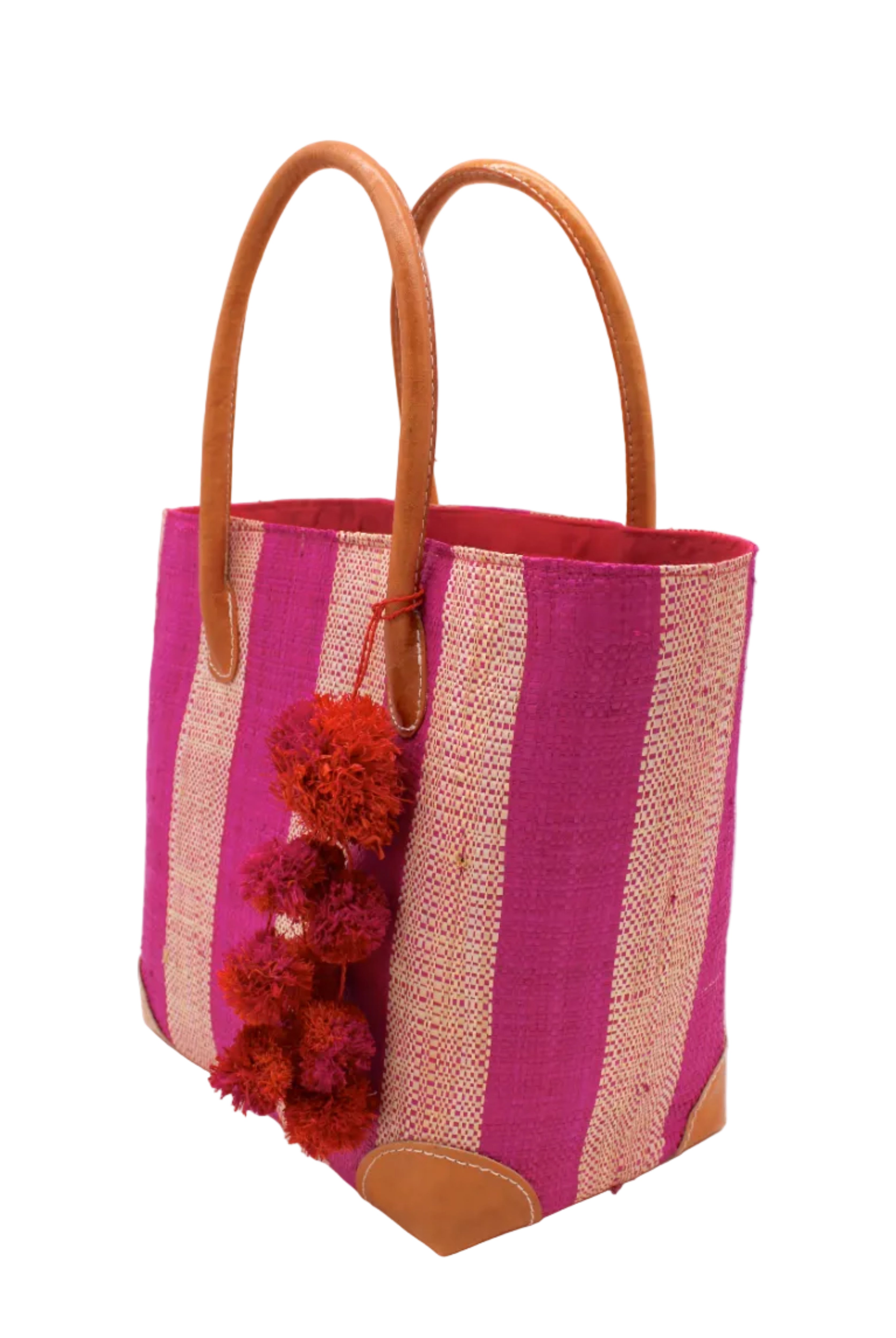 Side view Bora Bora Fuchsia Two Tone Stripes Straw Basket Bag with Waterfall Pompoms Charm Embellishment handmade loomed natural raffia palm fiber in a multicolor horizontal stripe pattern of even width wide bands of fuchsia hot/bright/barbie/pink and natural straw color with leather handles and feet plus matching waterfall pompom charm embellishment handbag beach bag - Shebobo