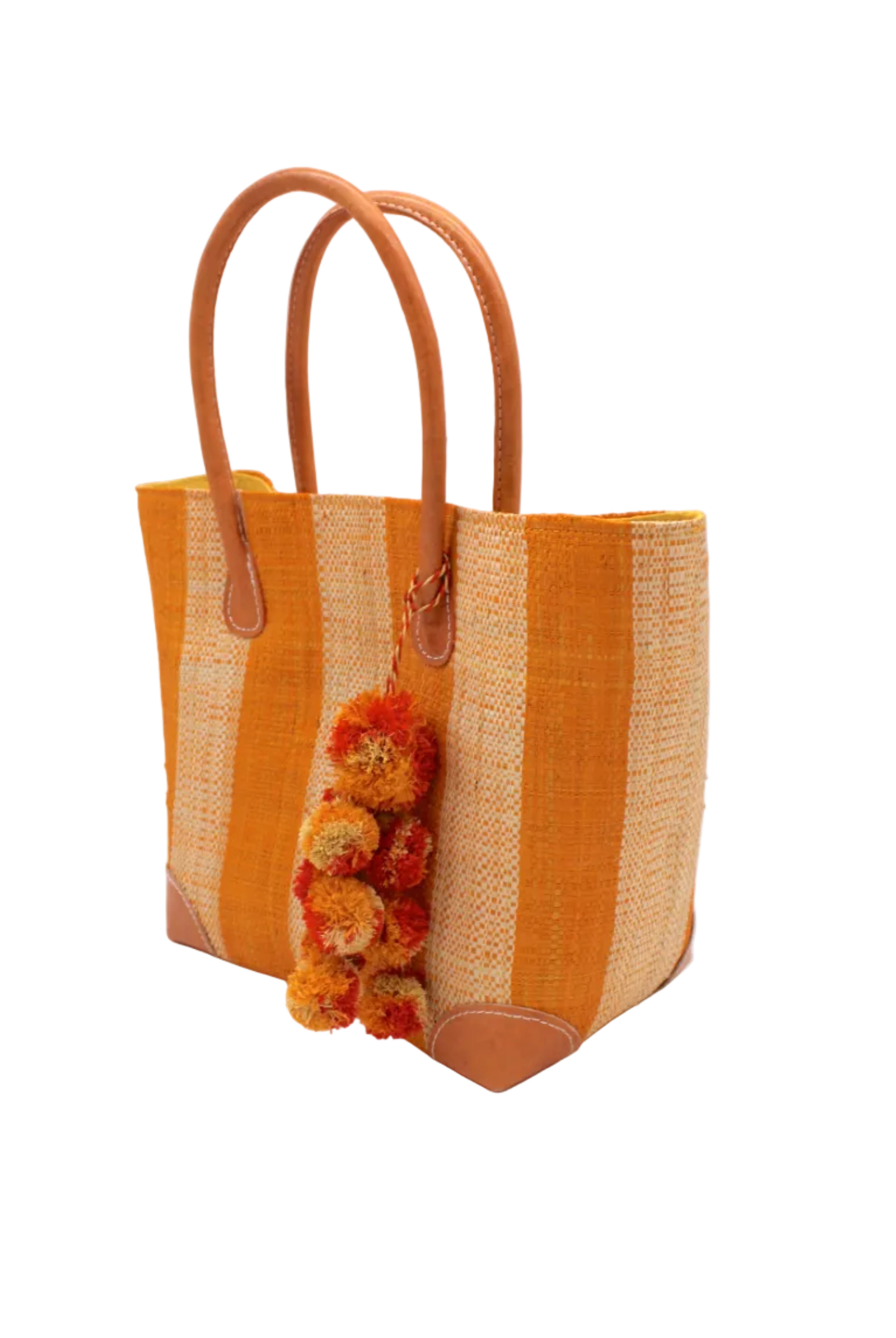 Side view Bora Bora Saffron Two Tone Stripes Straw Basket Bag with Waterfall Pompoms Charm Embellishment handmade loomed natural raffia palm fiber in a multicolor horizontal stripe pattern of even width wide bands of saffron orange/yellow and natural straw color with leather handles and feet plus matching waterfall pompom charm embellishment handbag beach bag - Shebobo