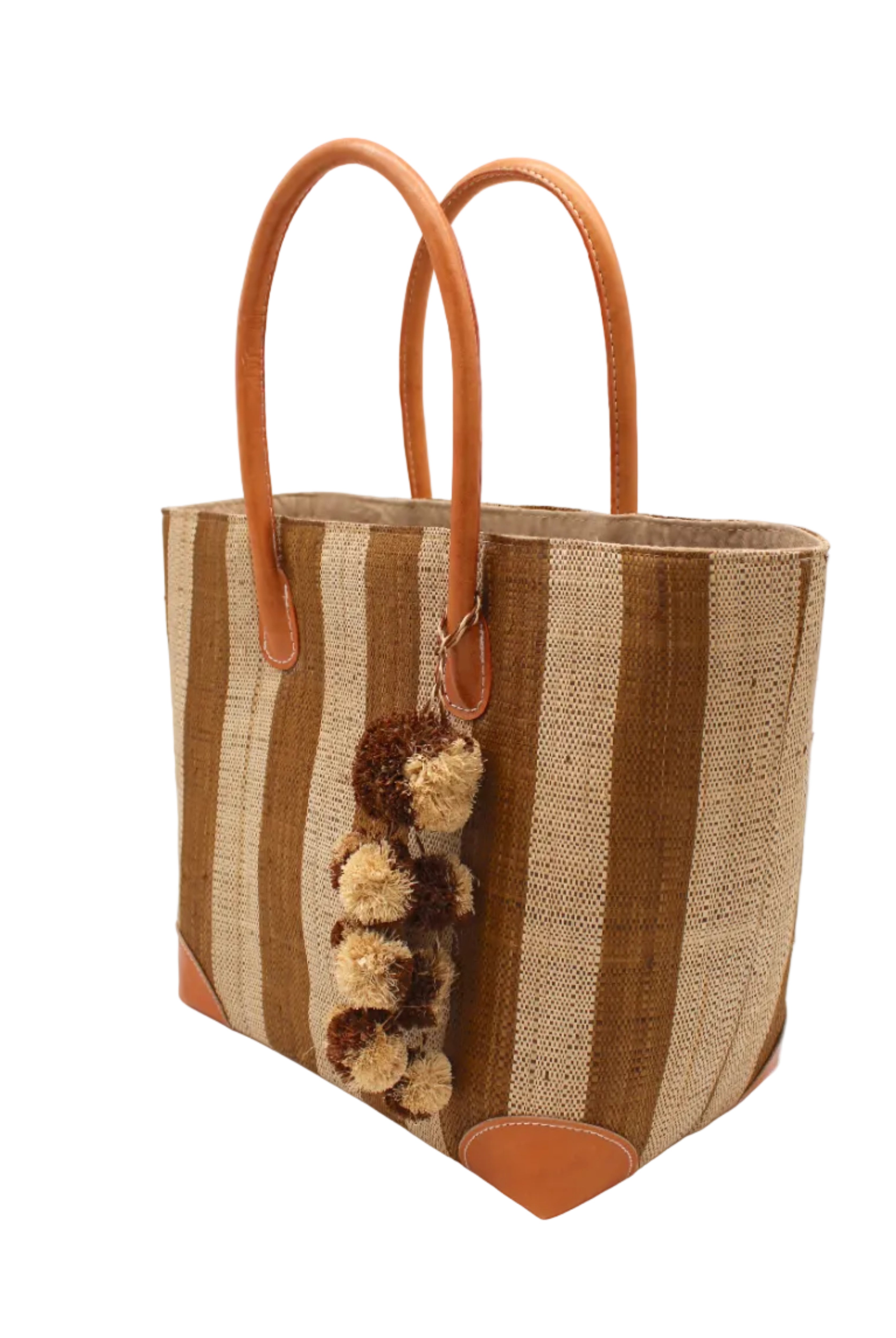 Side view Bora Bora Tobacco Two Tone Stripes Straw Basket Bag with Waterfall Pompoms Charm Embellishment handmade loomed natural raffia palm fiber in a multicolor horizontal stripe pattern of even width wide bands of tobacco cinnamon/dark/brown and natural straw color with leather handles and feet plus matching waterfall pompom charm embellishment handbag beach bag - Shebobo