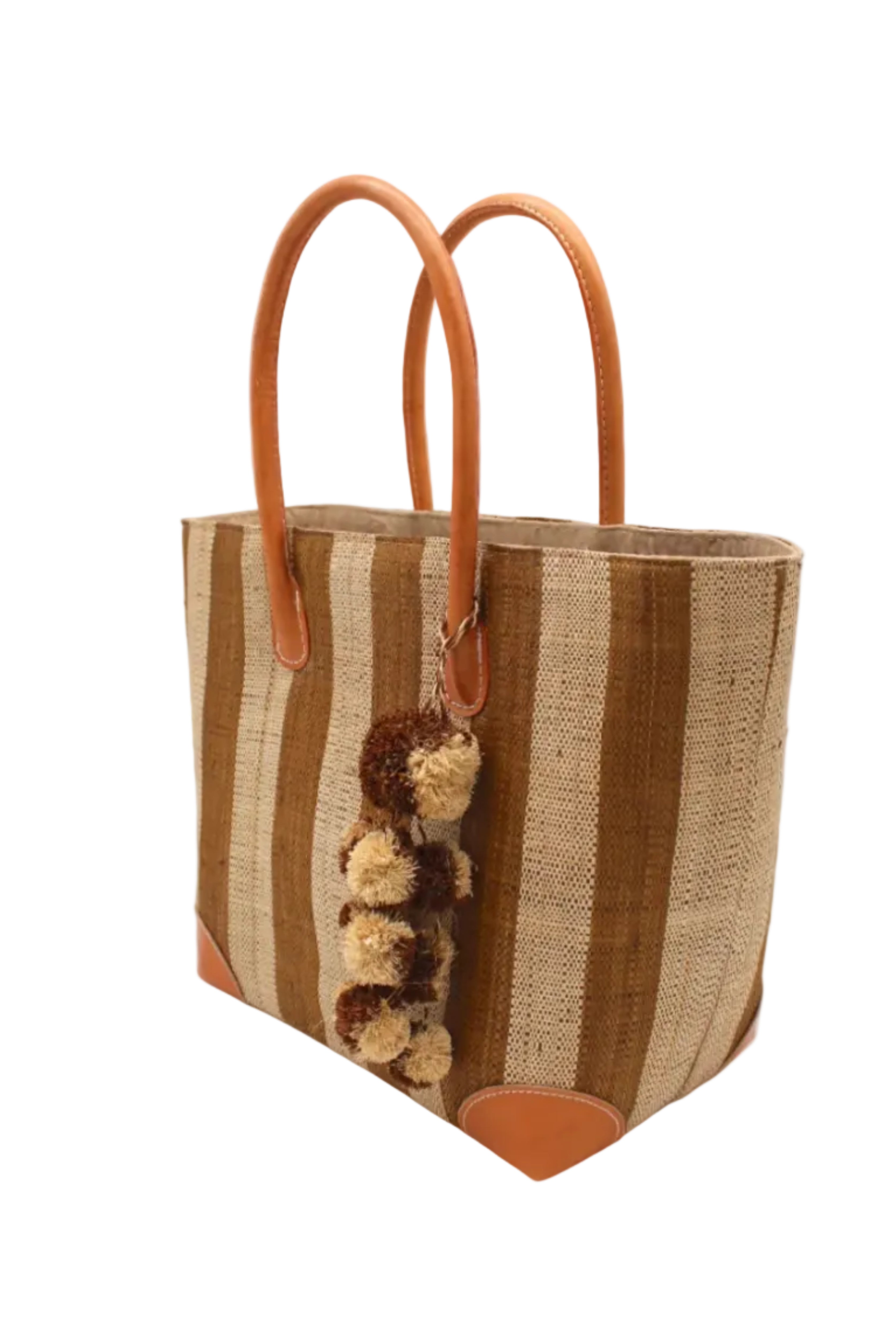 Side view Bora Bora Tobacco Two Tone Stripes Straw Basket Bag with Waterfall Pompoms Charm Embellishment handmade loomed natural raffia palm fiber in a multicolor horizontal stripe pattern of even width wide bands of tobacco cinnamon/dark/brown and natural straw color with leather handles and feet plus matching waterfall pompom charm embellishment handbag beach bag - Shebobo