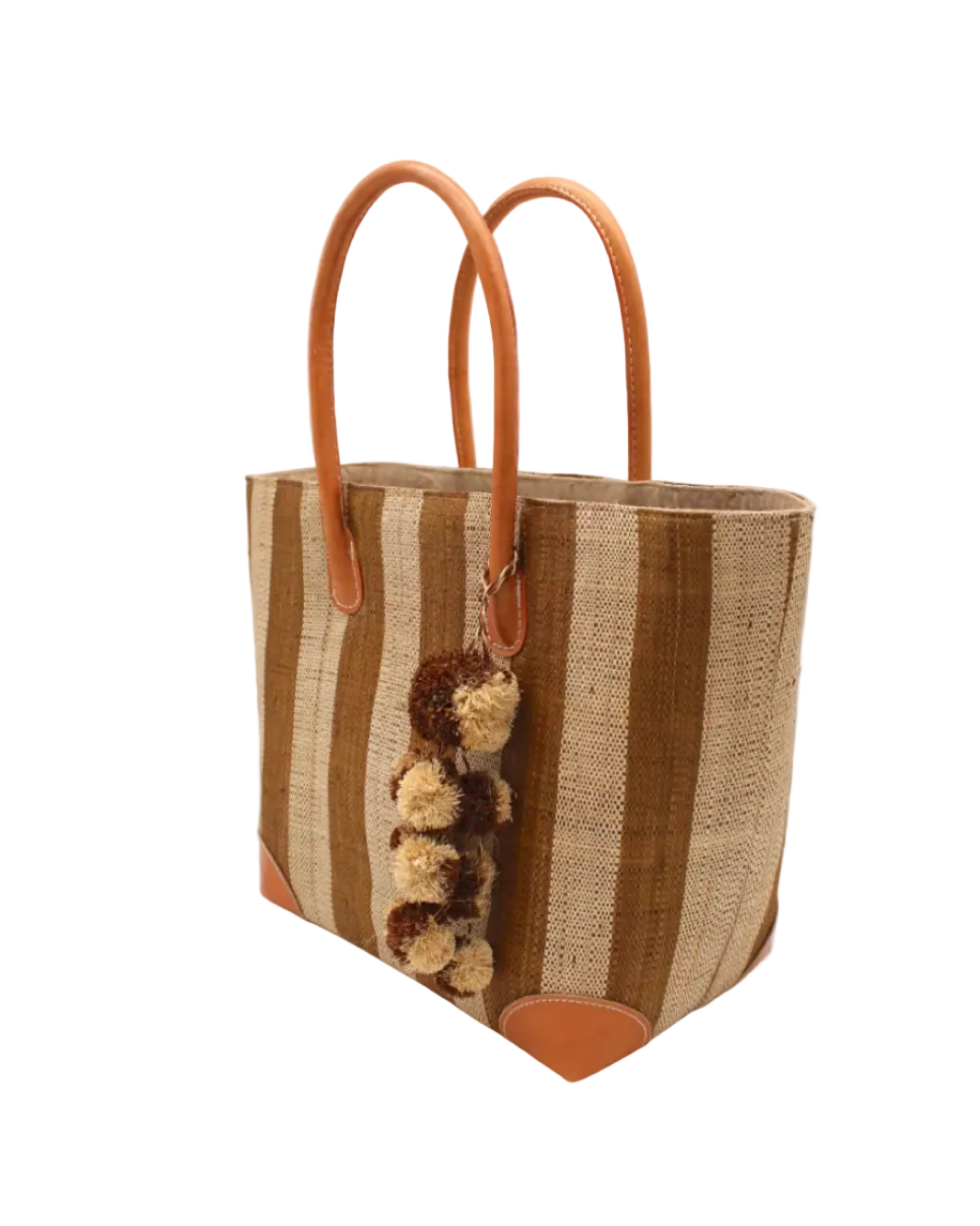 Side view Bora Bora Tobacco Two Tone Stripes Straw Basket Bag with Waterfall Pompoms Charm Embellishment handmade loomed natural raffia palm fiber in a multicolor horizontal stripe pattern of even width wide bands of tobacco cinnamon/dark/brown and natural straw color with leather handles and feet plus matching waterfall pompom charm embellishment handbag beach bag - Shebobo