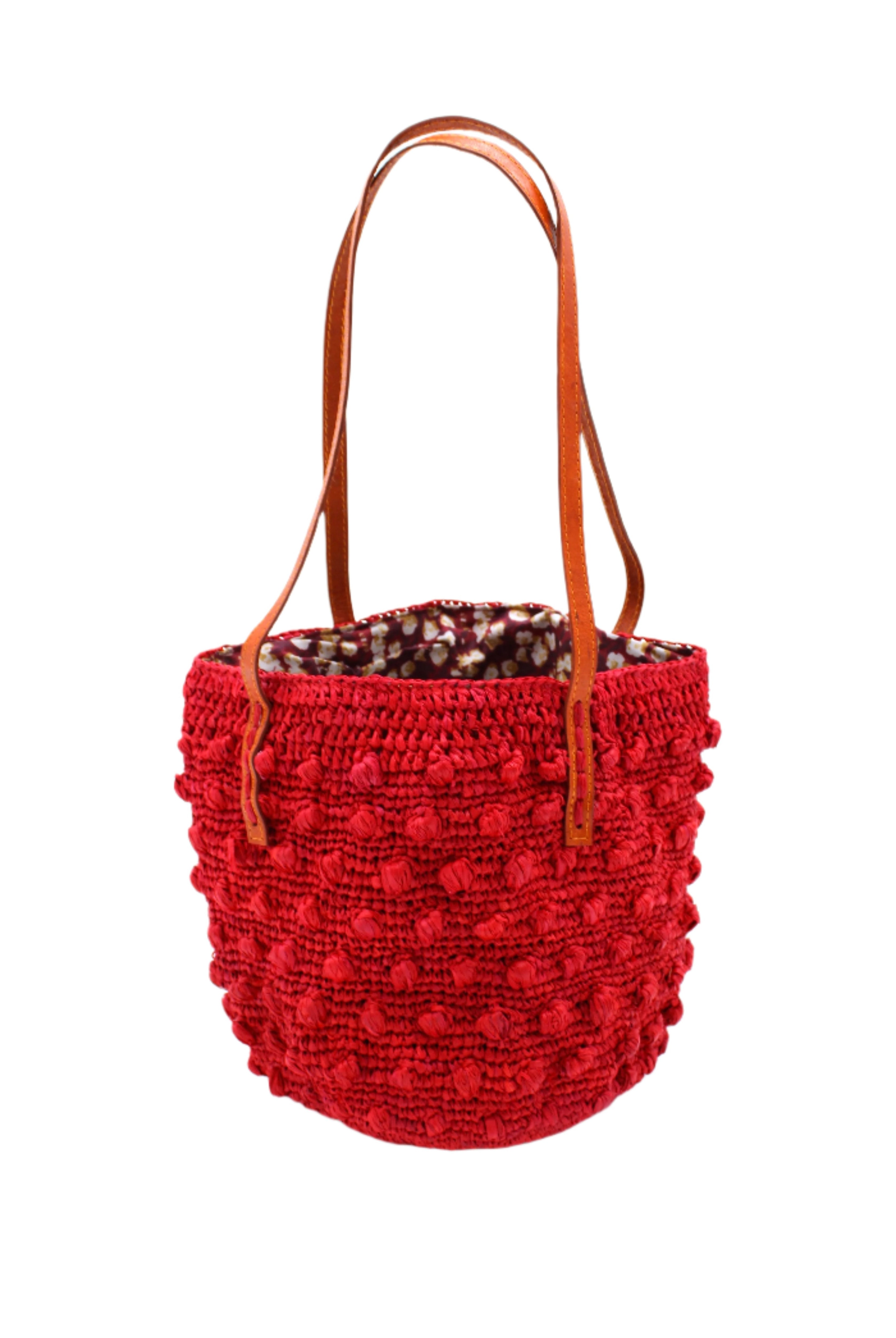 Boucle Red Crochet Small Straw Handbag handmade woven raffia palm fiber in a solid hue of red in a supple nub/ball texture of horizontal bands around the bag with link weave around the top plus assorted print drawstring liner and leather handles shoulder bag purse - Shebobo
