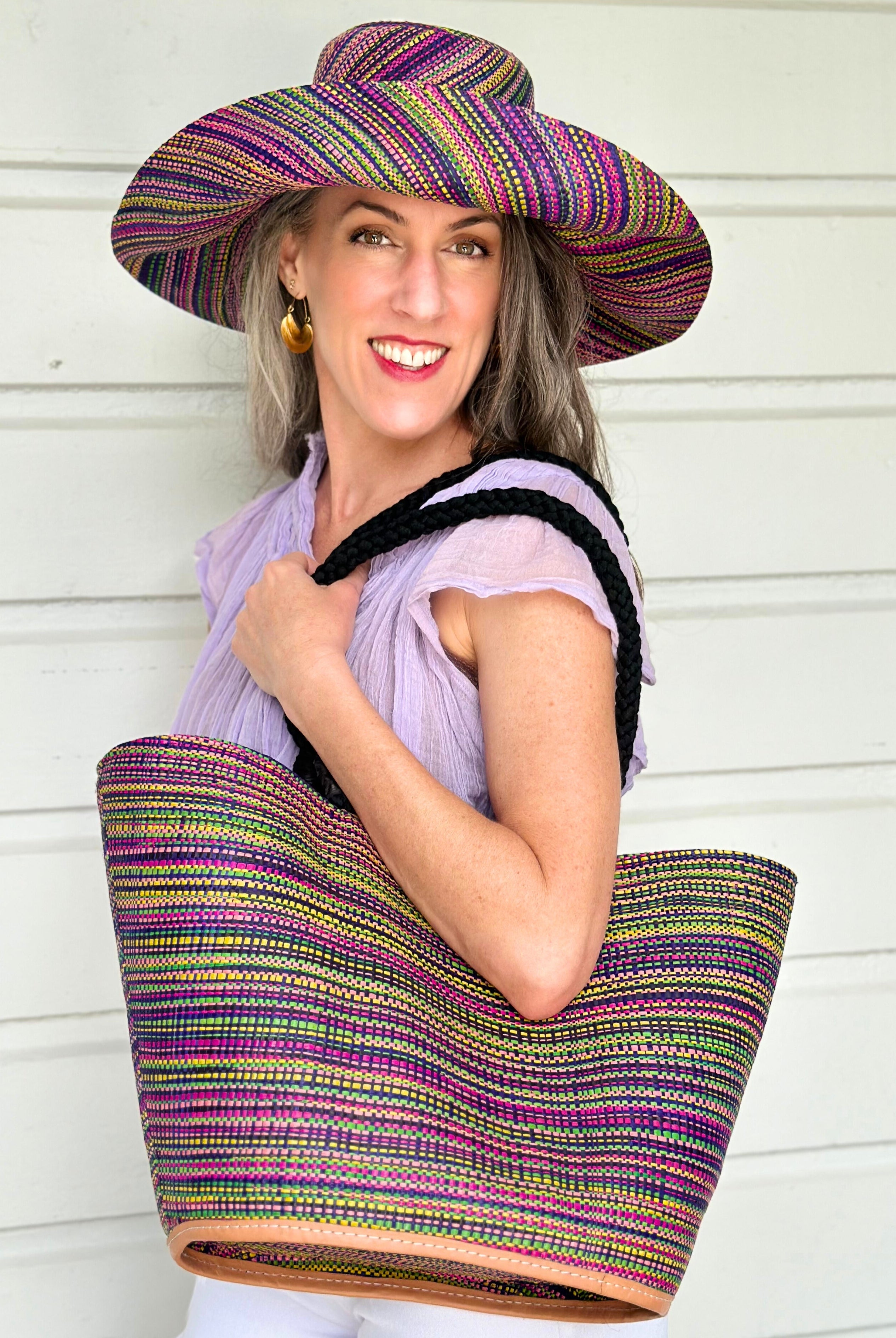 Model wearing Monica 5" & 7" Wide Brim Orchid Multi Melange Packable Straw Sun Hat multicolor heather pattern of orchid purple, fuchsia pink, navy blue, green, yellow, pink, black, etc. with matching Brighton Multi Melange Straw Beach Tote Bag with Rope Handle Handbag Beach Bag Tote - Shebobo
