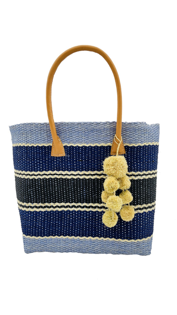 Cabrillo Blue Multi Sisal Basket Bag with Waterfall Pompoms Charm Embellishment handmade woven natural sisal fiber in multiple horizontal width stripes of light/baby/blue, navy/dark/blue, black, and natural straw color in a stripe pattern handbag with leather handles - Shebobo'