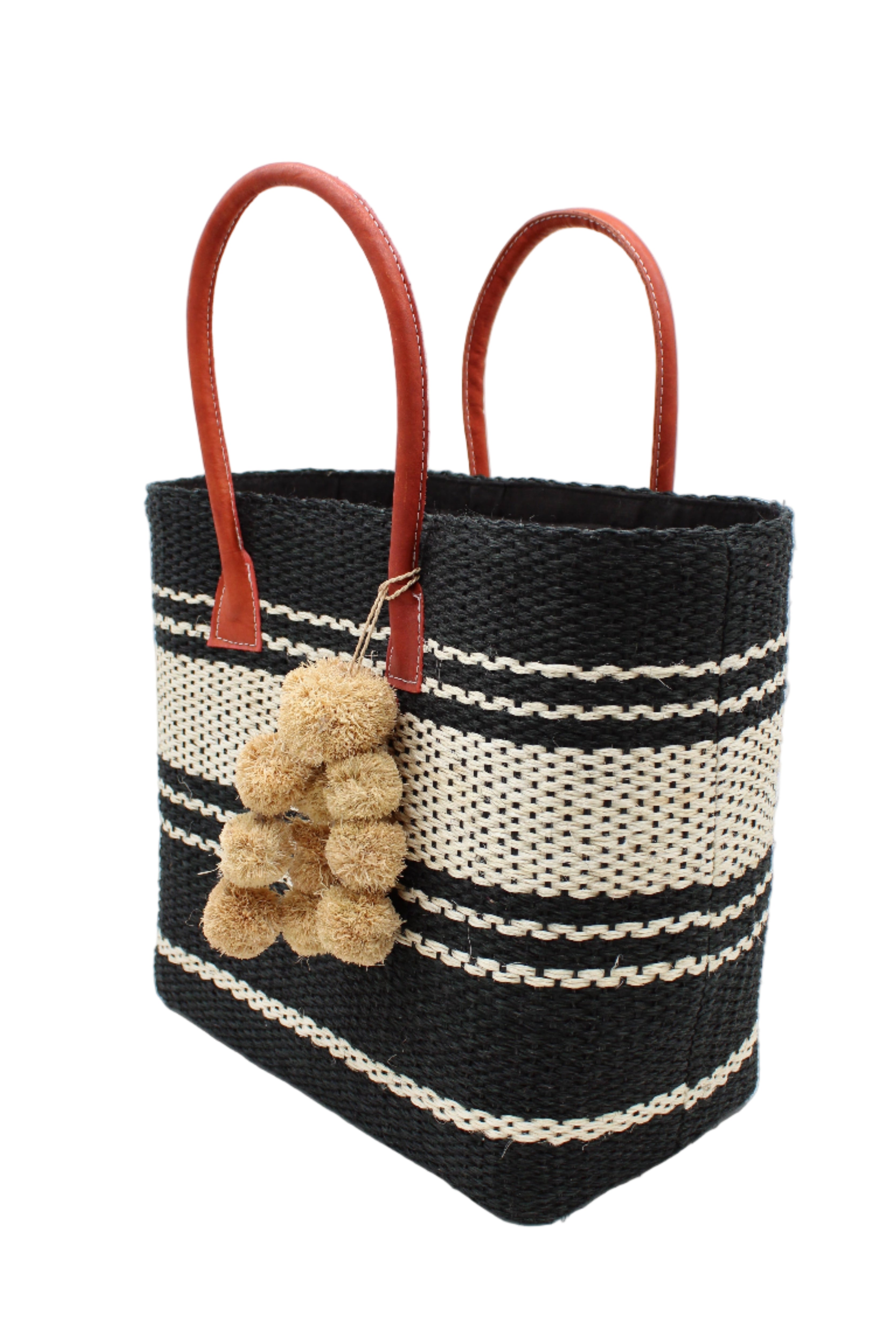 Side view Cabrillo Sisal Basket Bag with Waterfall Pompoms Charm Embellishment handmade natural sisal fiber woven into a multicolor two tone Black and natural straw color horizontal stripe pattern with muti-width bands of color plus leather handles and natural raffia charm shoulder bag beach bag - Shebobo