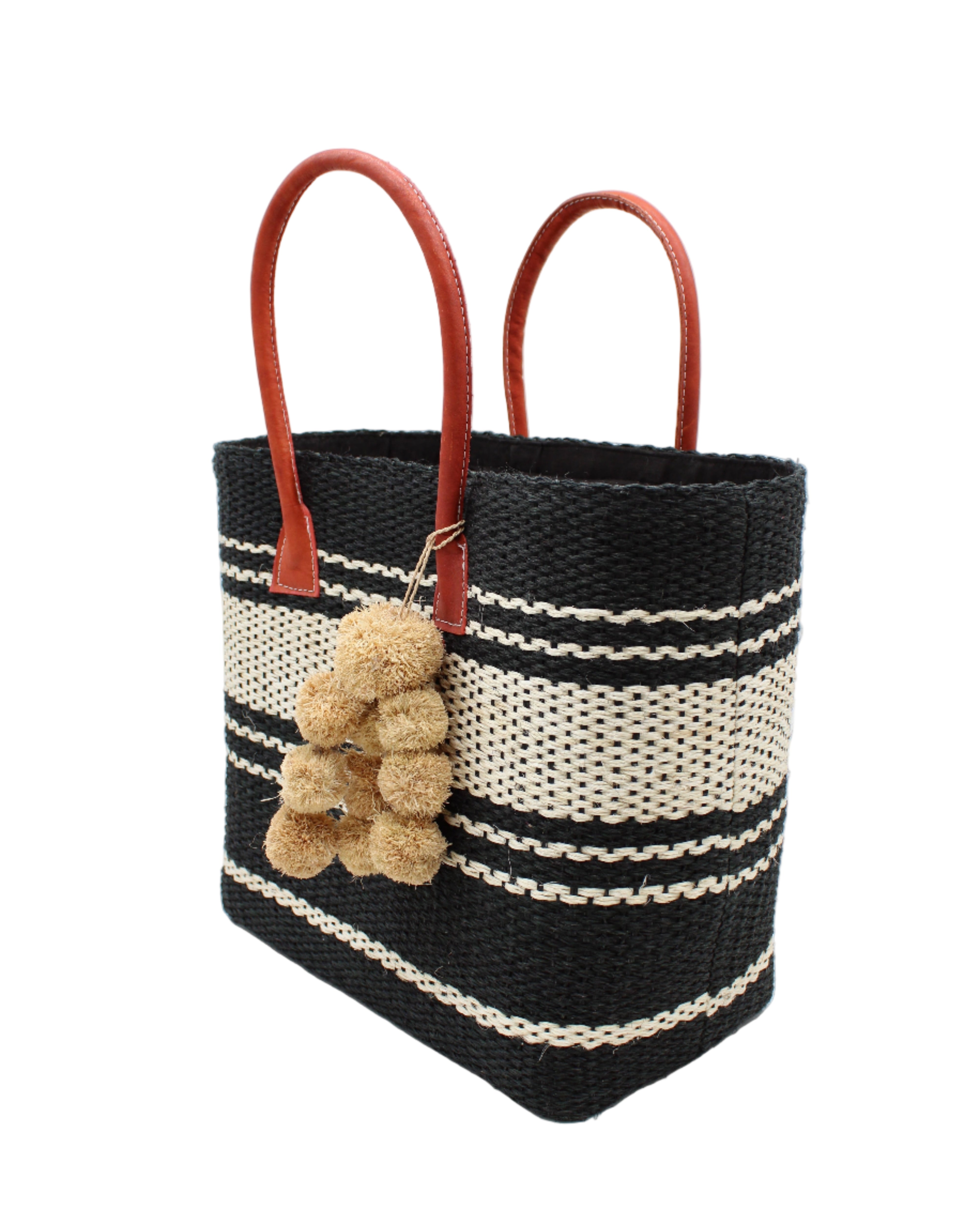 Side view Cabrillo Sisal Basket Bag with Waterfall Pompoms Charm Embellishment handmade natural sisal fiber woven into a multicolor two tone Black and natural straw color horizontal stripe pattern with muti-width bands of color plus leather handles and natural raffia charm shoulder bag beach bag - Shebobo