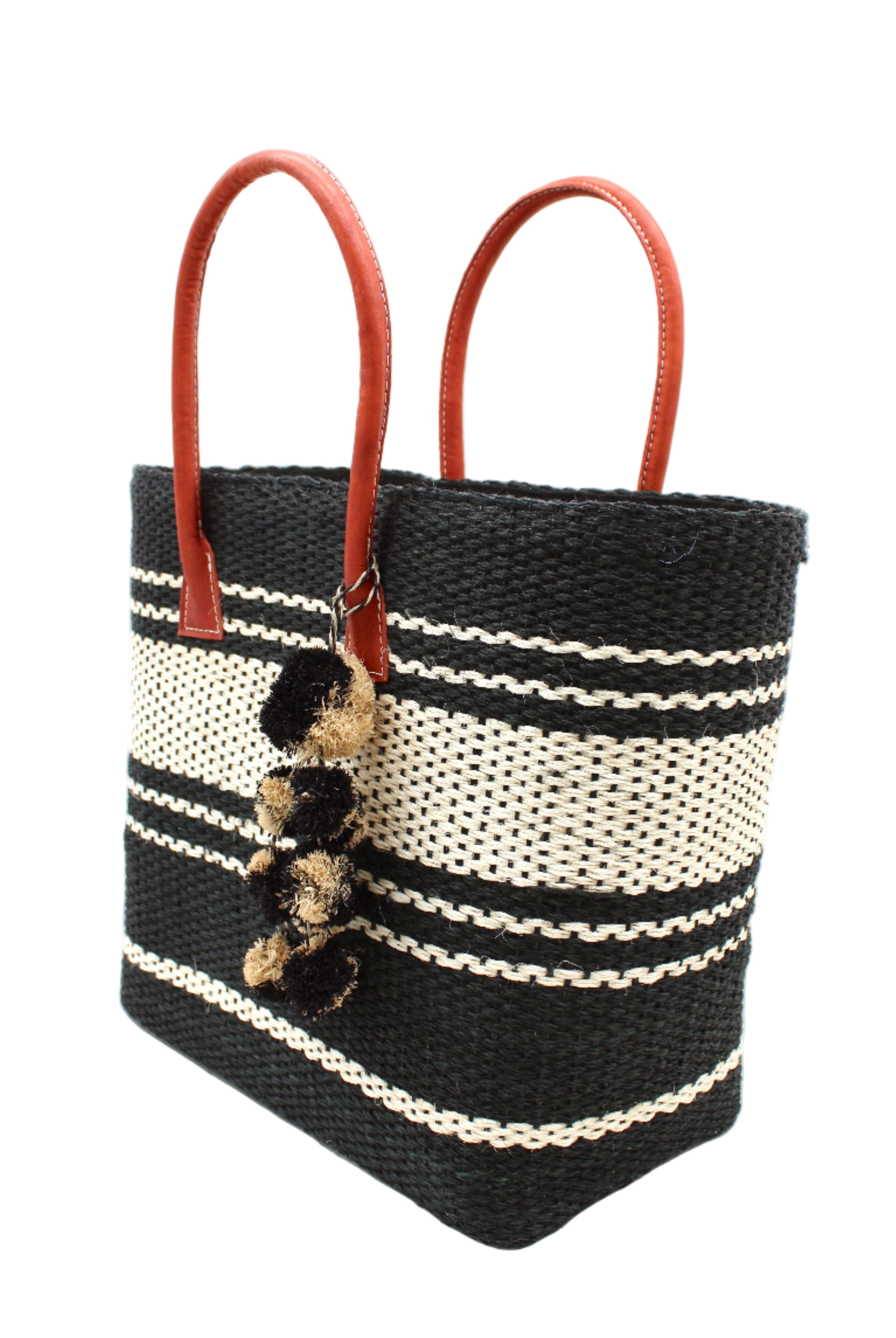 Side view Cabrillo Sisal Basket Bag with Waterfall Pompoms Charm Embellishment handmade natural sisal fiber woven into a multicolor two tone Black and natural straw color horizontal stripe pattern with muti-width bands of color plus leather handles and multicolor raffia charm shoulder bag beach bag - Shebobo