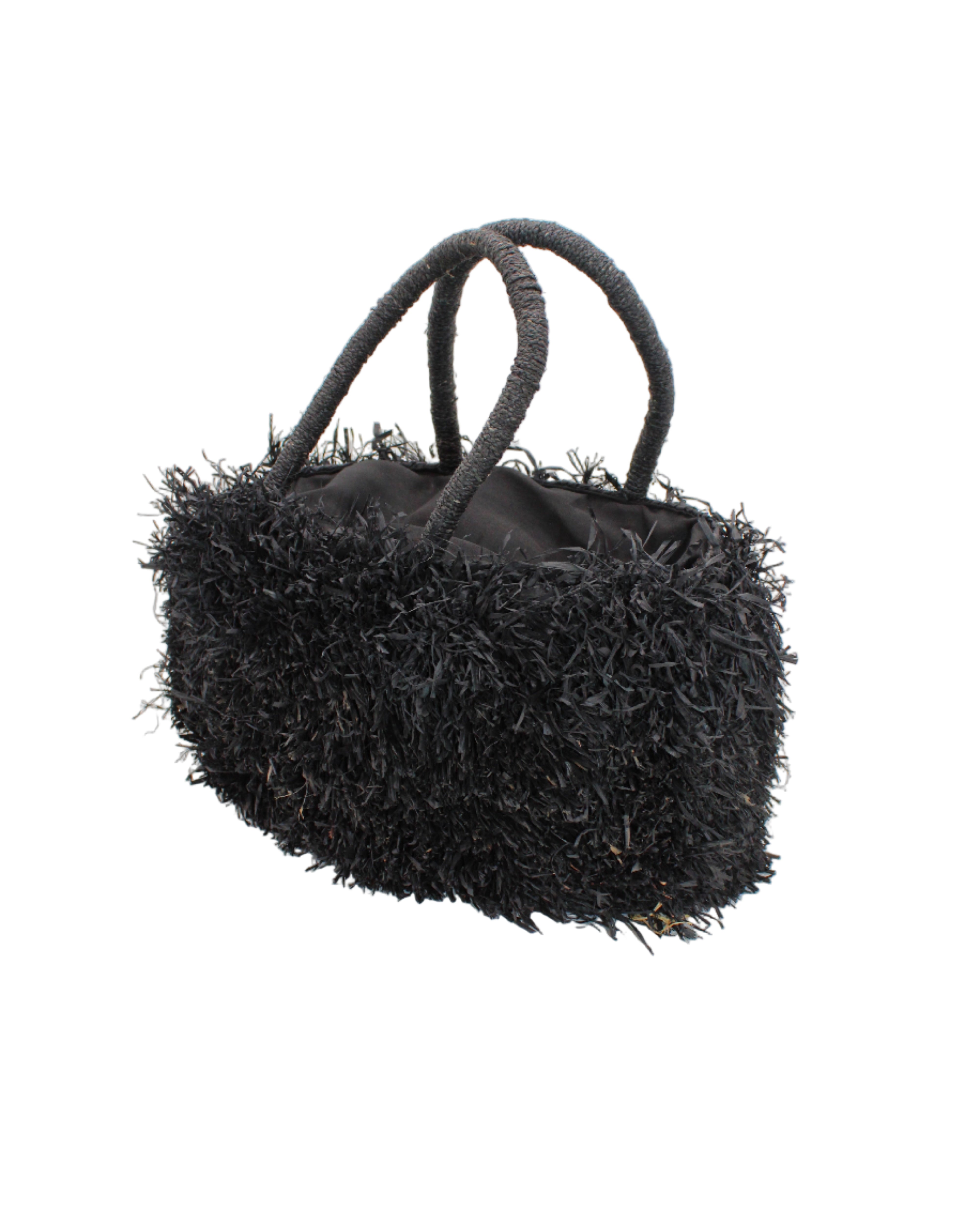 Side view Calypso Pompom Pouf Crochet Straw Basket Handbag handmade natural raffia palm fiber in a solid hue of Black with brushed fringe strands crochet and knotted into a pouf texture with matching wrapped handles purse - Shebobo