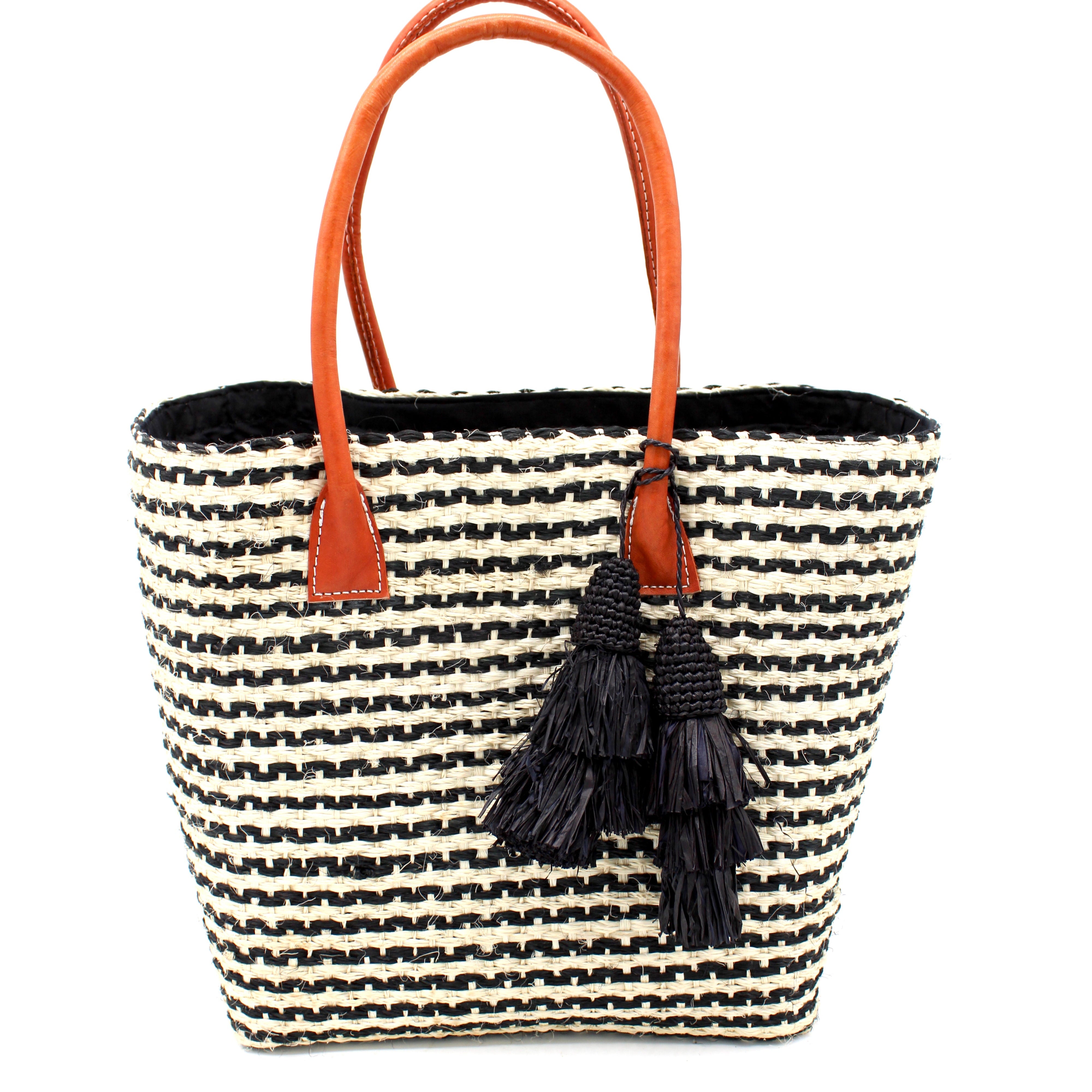 Cancun Small Sisal Basket Bag with Tassel Charm handmade natural sisal fibers woven into even width horizontal bands of black and natural straw color that create a pinstripe pattern with matching knotted raffia tufts tassel charm embellishment and leather handles beach bag - Shebob