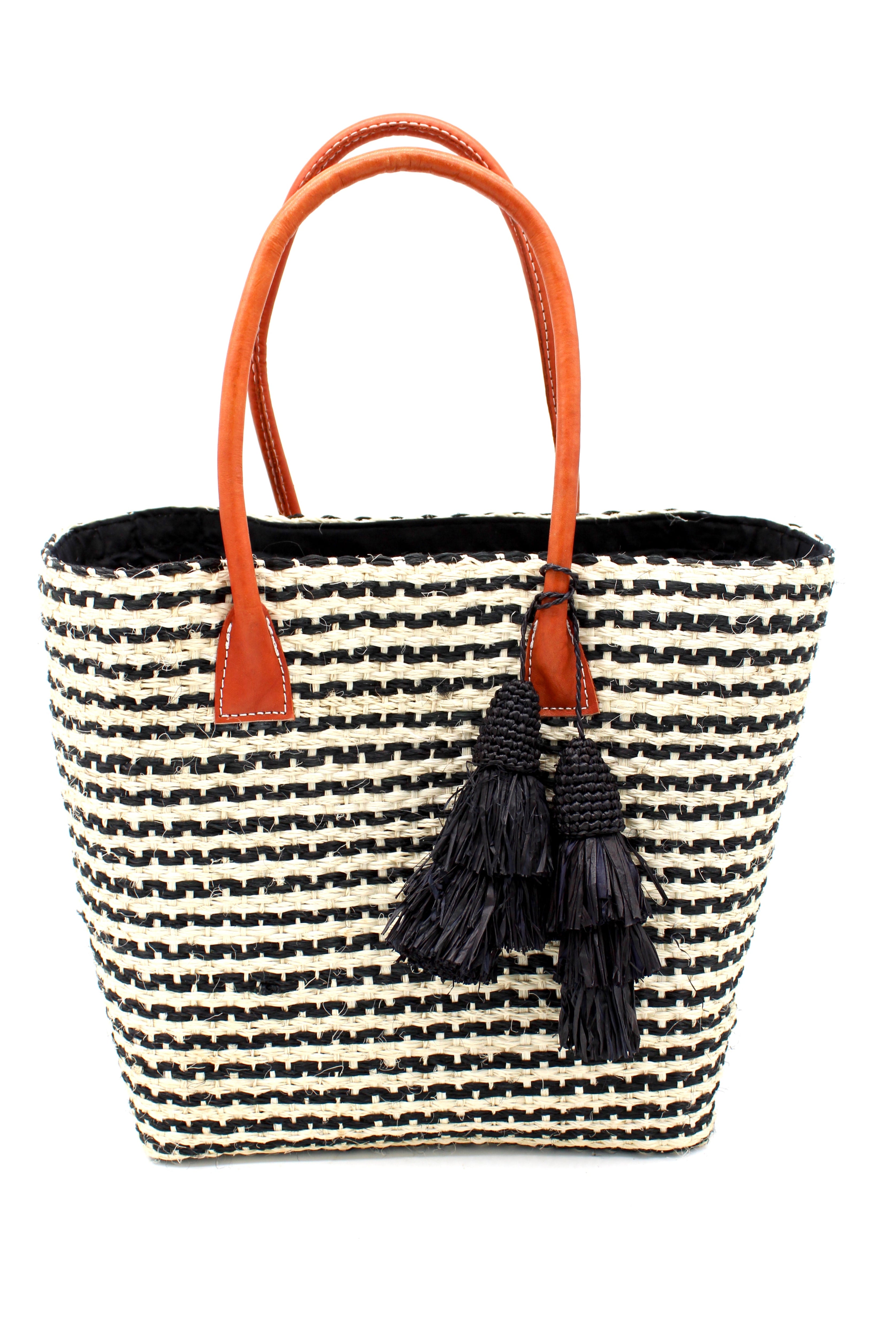 Cancun Small Sisal Basket Bag with Tassel Charm handmade natural sisal fibers woven into even width horizontal bands of black and natural straw color that create a pinstripe pattern with matching knotted raffia tufts tassel charm embellishment and leather handles beach bag - Shebob