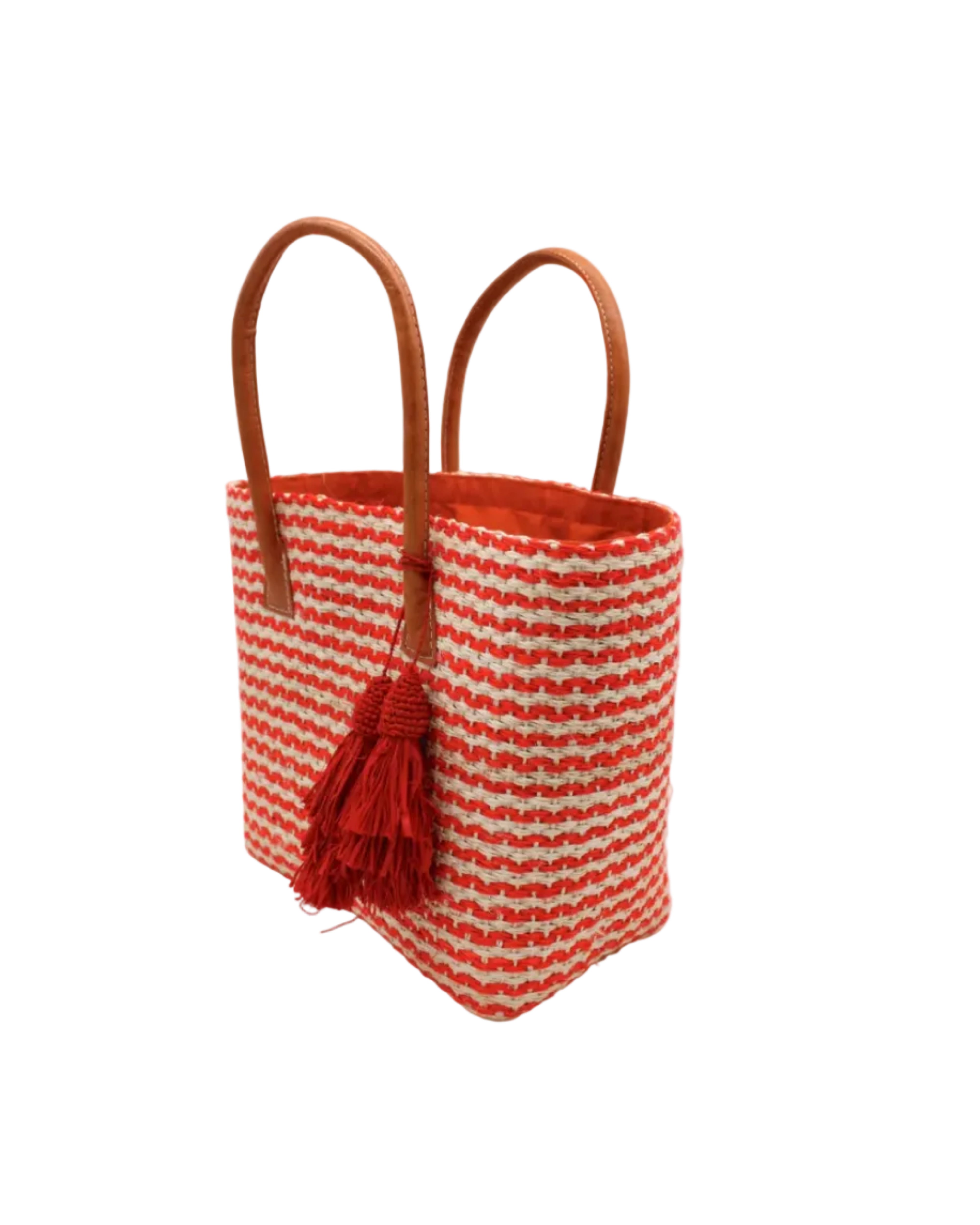 Side view Cancun Small Sisal Basket Bag with Tassel Charm handmade natural sisal fibers woven into even width horizontal bands of coral orange and natural straw color that create a pinstripe pattern with matching knotted raffia tufts tassel charm embellishment and leather handles beach bag - Shebobo