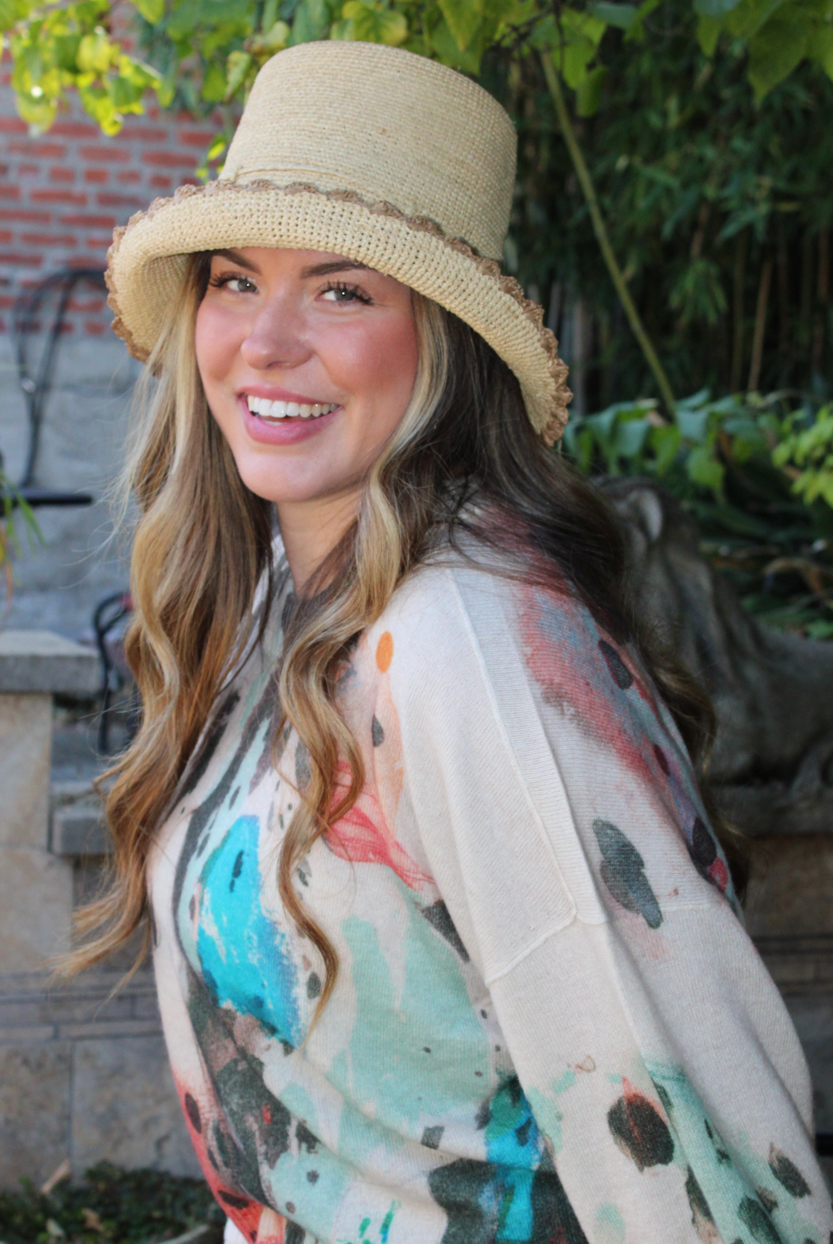 Model wearing Kate Natural with Cappuccino Crochet Bucket Straw Hats with Colored Lace Weave Edge handmade woven raffia palm fiber in a solid hue of natural straw color in a subtle link texture with cappuccino tea/light/brown lace weave floral edge trim around the outer brim two tone multicolor uv protection hat - Shebobo