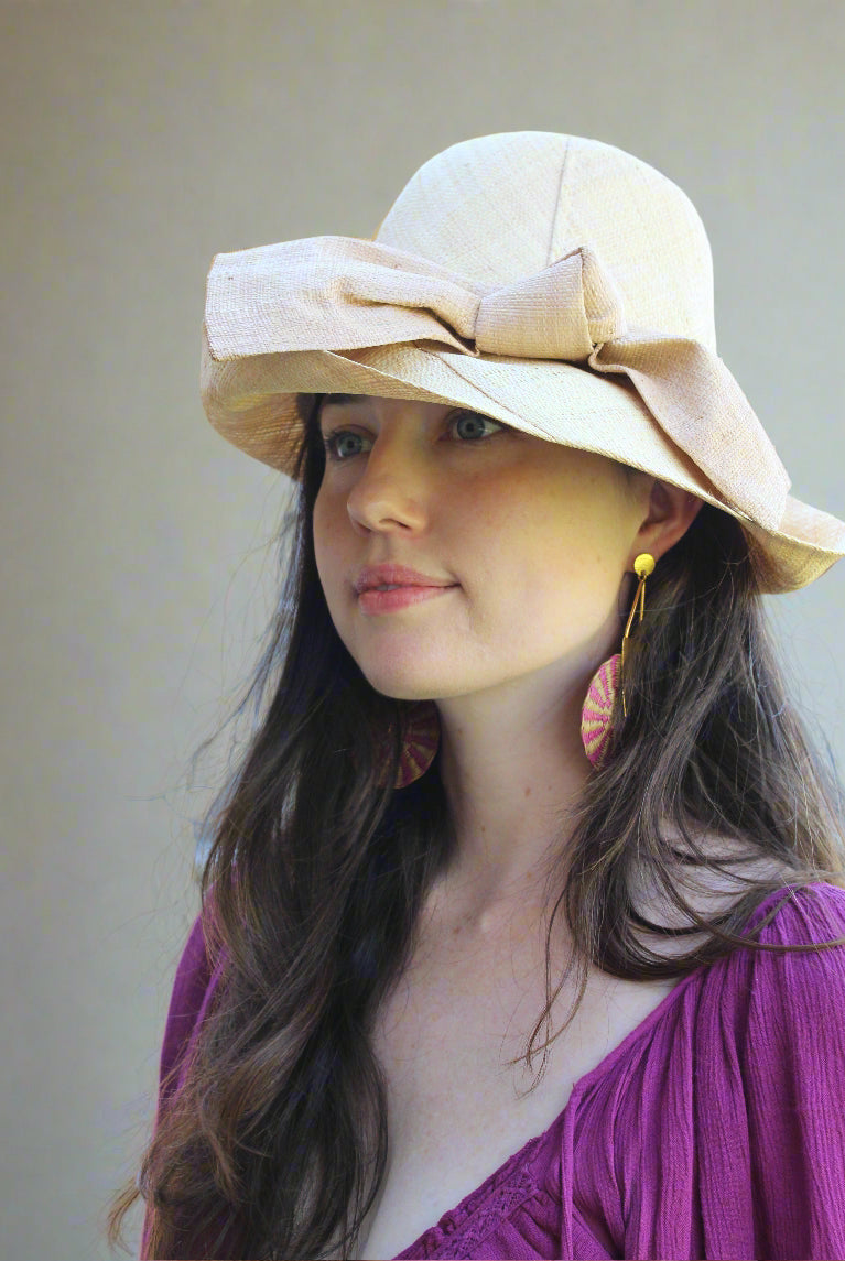Model wearing Cara Big Bow Straw Hat Handmade loomed raffia straw hat solid natural bucket hat with large cappuccino tea/light/brown bow - Shebobo